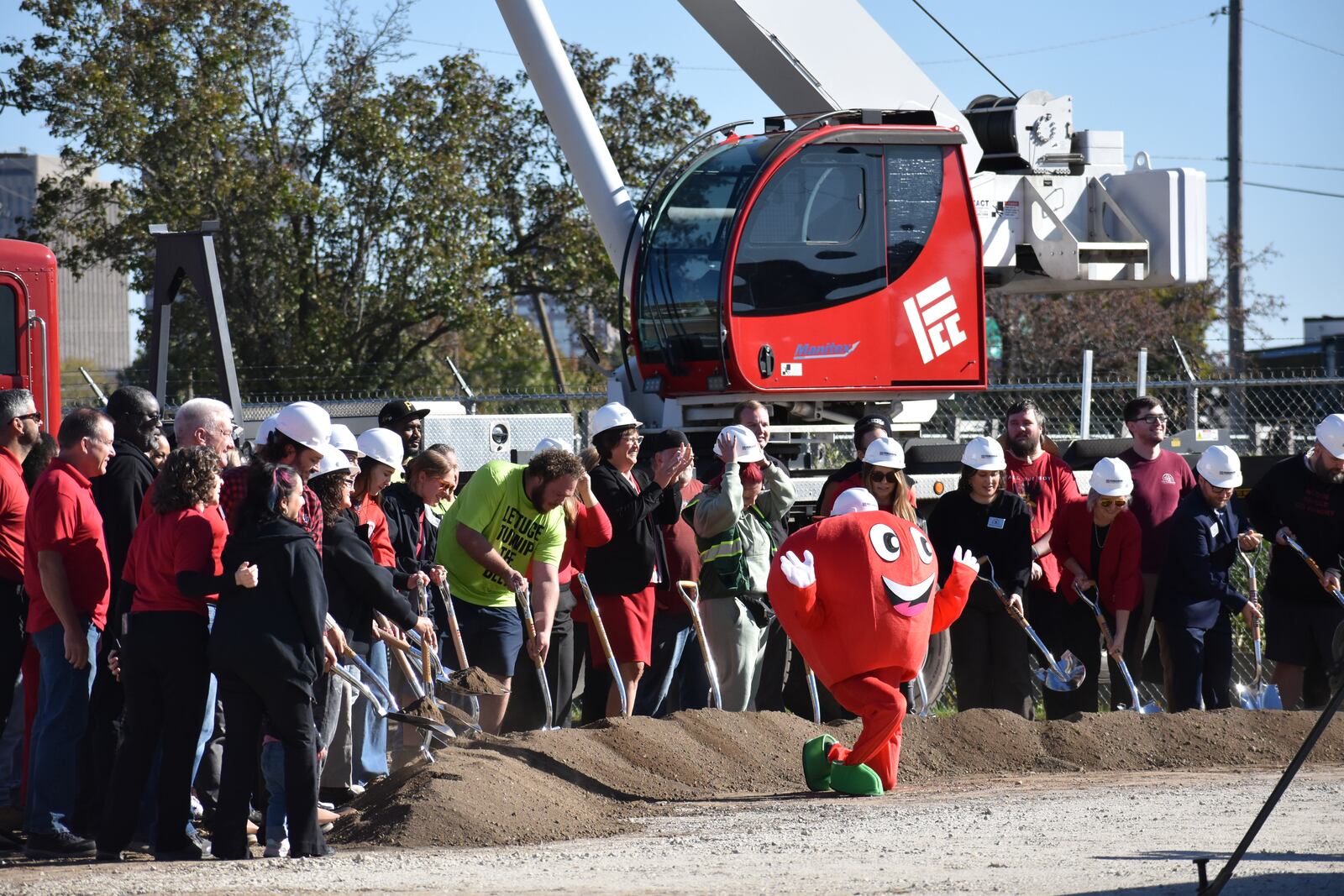 Dayton Foodbank Inc. workers, volunteers and other team members join in breaking ground at the location of a new $4.5 million community building for the Foodbank. SAM WILDOW\STAFF