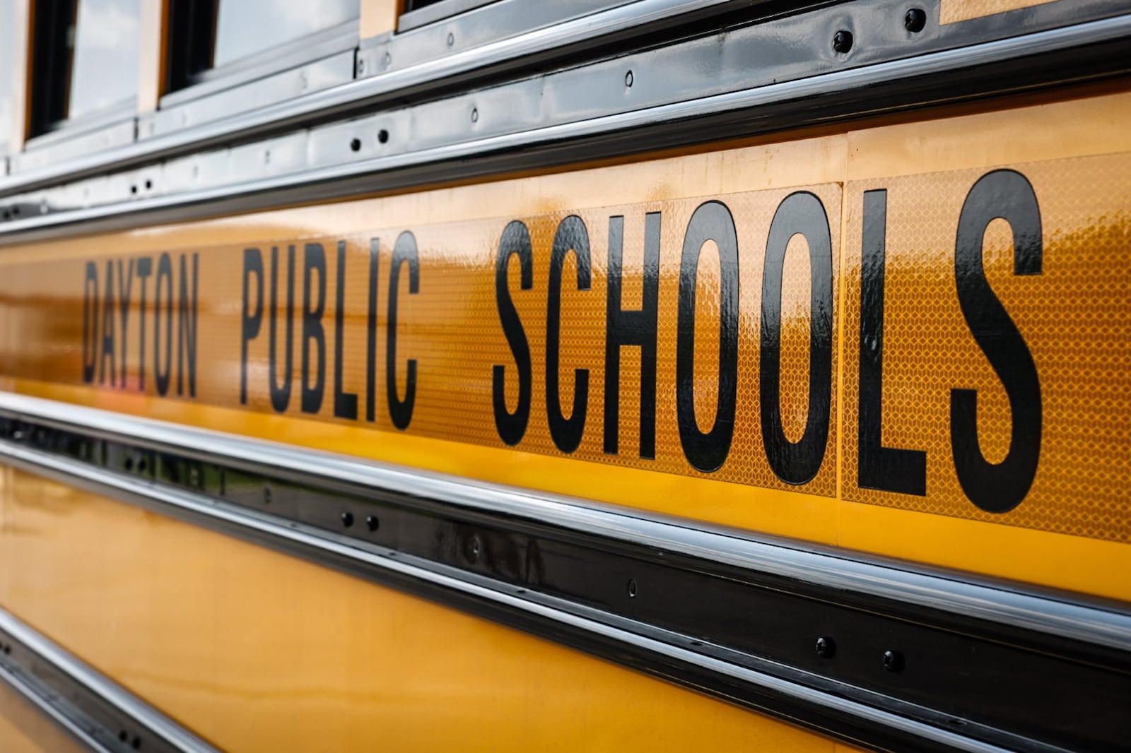 A Dayton Public School bus sits in the bus lot on James H. McGee Blvd. in Dayton. JIM NOELKER/STAFF