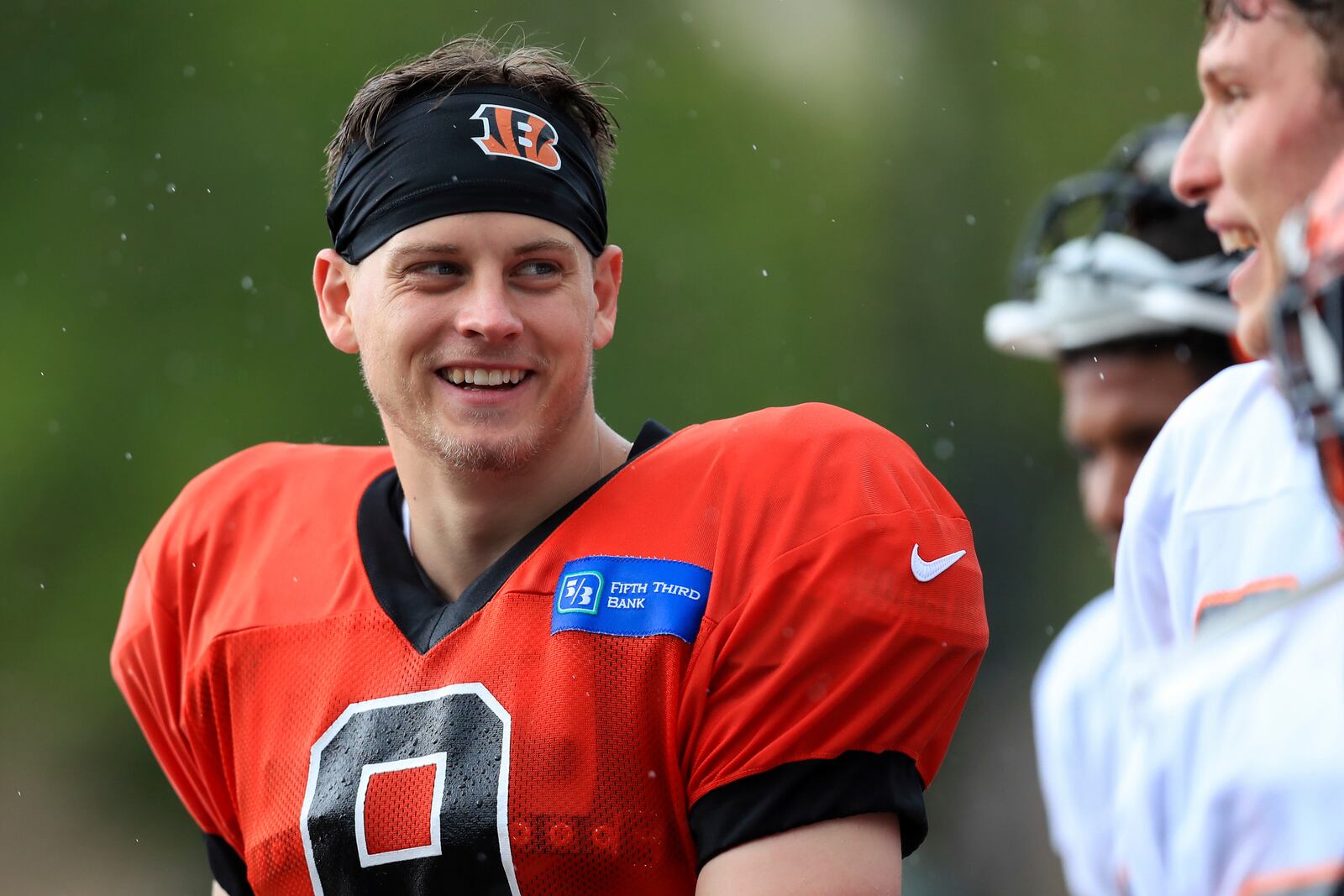 Cincinnati Bengals' Joe Burrow (9) reacts to a teammate as he walks off the practice field after an NFL football camp practice in Cincinnati, Tuesday, Aug. 18, 2020. (AP Photo/Aaron Doster)