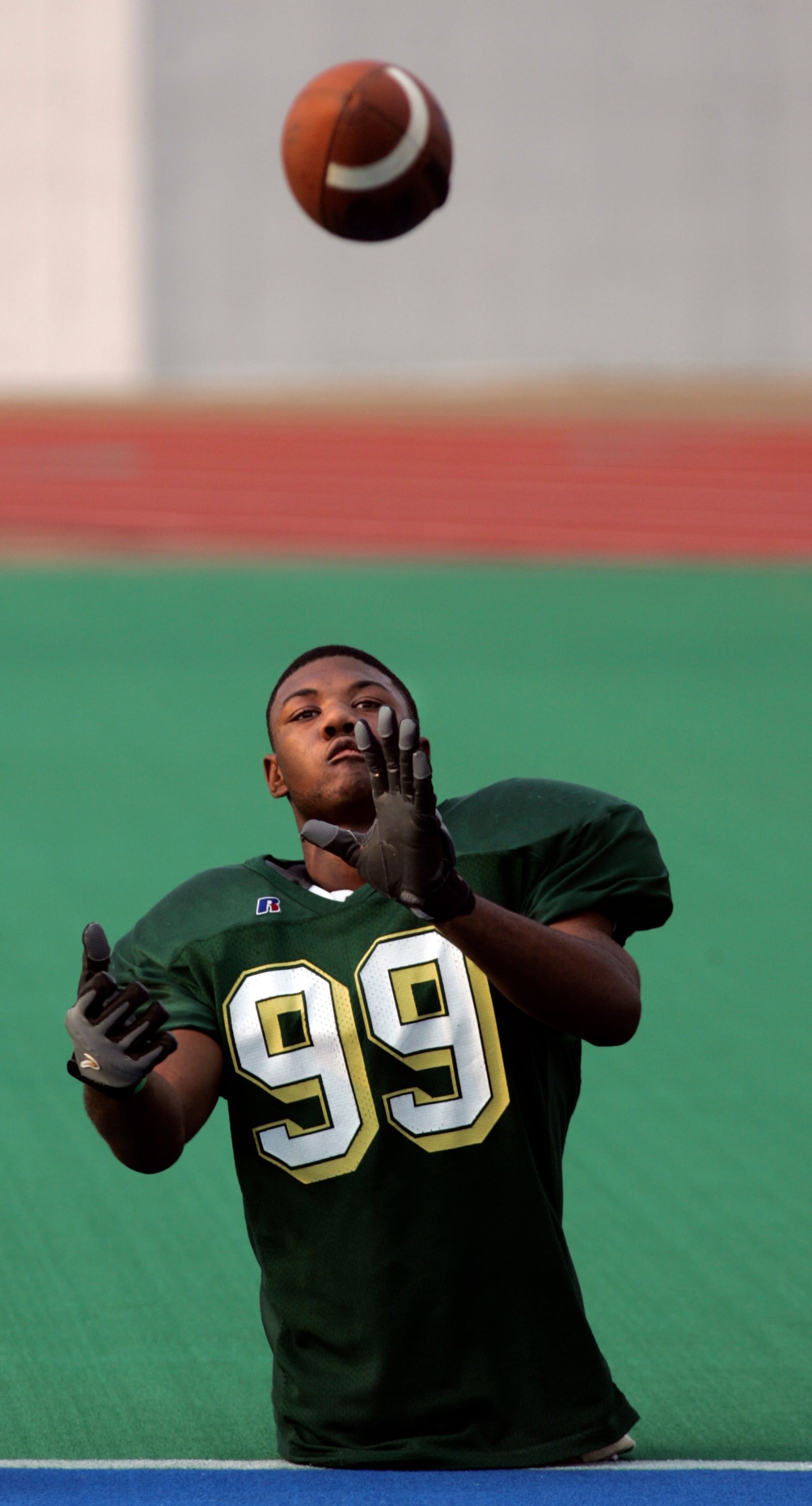 Colonel White's Bobby Martin warms up with a passing drill on the sidelines before a game with Dunbar. Photo by Jim Witmer