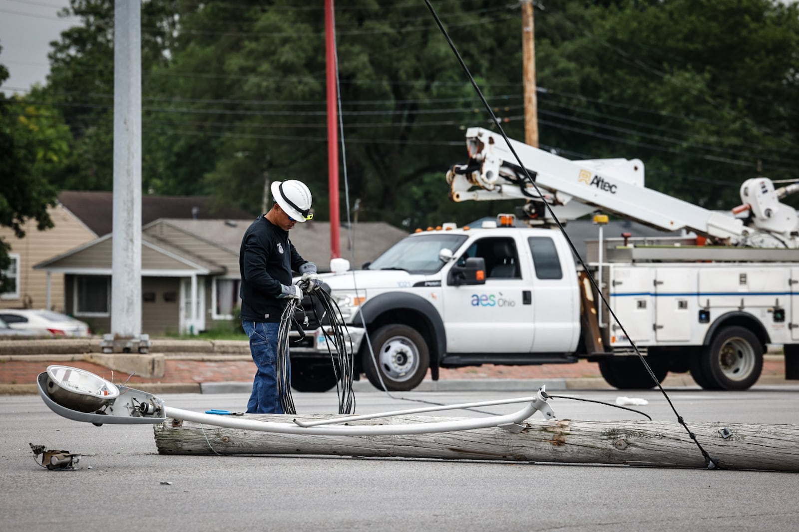 An AES crew responded to a crash scene after the impact snapped a utility pole at its base. A police pursuit involving a stolen car that fled from police Friday afternoon, June 23, 2023, ended in a three-vehicle injury crash at North Springboro Pike and South Dixie Avenue in Moraine. JIM NOELKER/STAFF