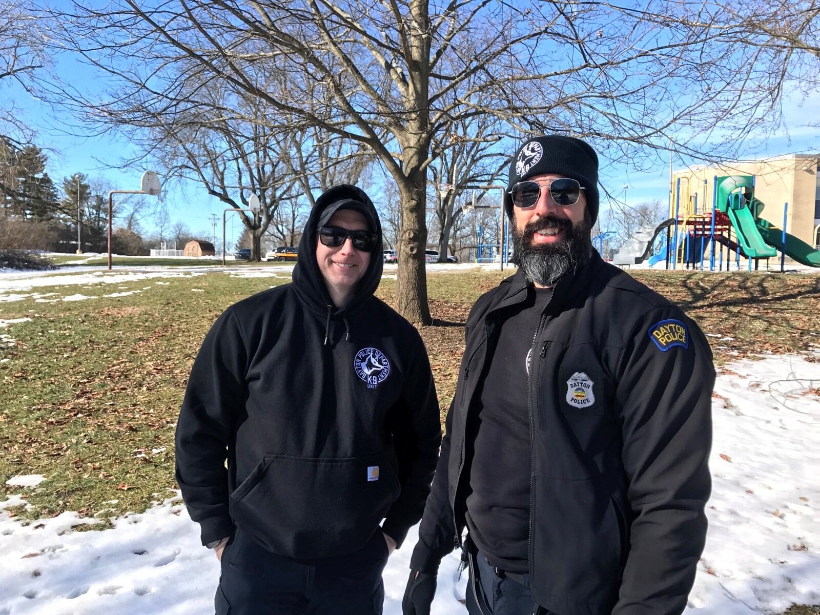 Dayton Police K-9 handlers Officer Nathan Speelman and Detective Ross Nagy at a recent training session for their dogs, who are also police officers. Nate has a Belgian Malinois named Scooby Doo and Ross has a yellow Labrador retriever named North. Tom Archdeacon/CONTRIBUTED