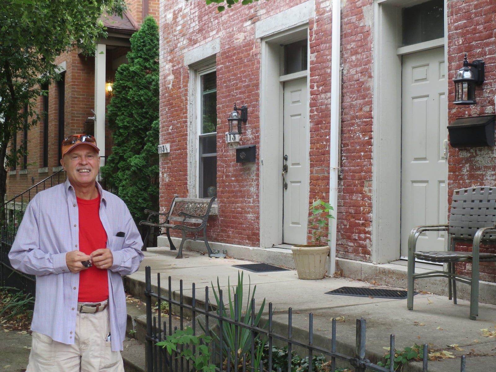 Spencer Myers in front of the 140 year old home in the Oregon District that he renovated. It was the first home in the area to have solar panels installed.