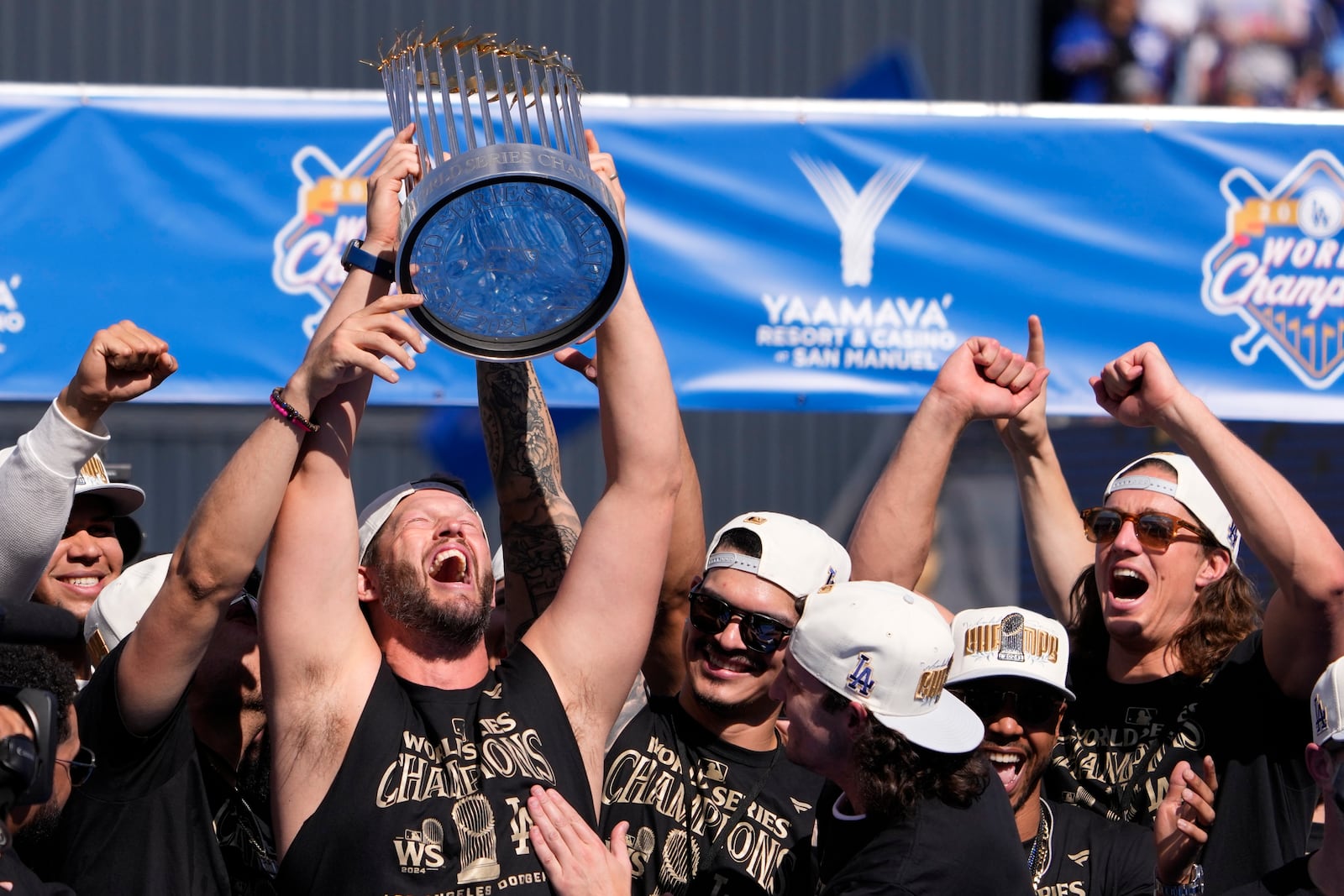 Los Angeles Dodgers pitcher Clayton Kershaw hold the World Series trophy during the baseball team's World Series championship parade and celebration at Dodger Stadium, Friday, Nov. 1, 2024, in Los Angeles. (AP Photo/Mark J. Terrill)