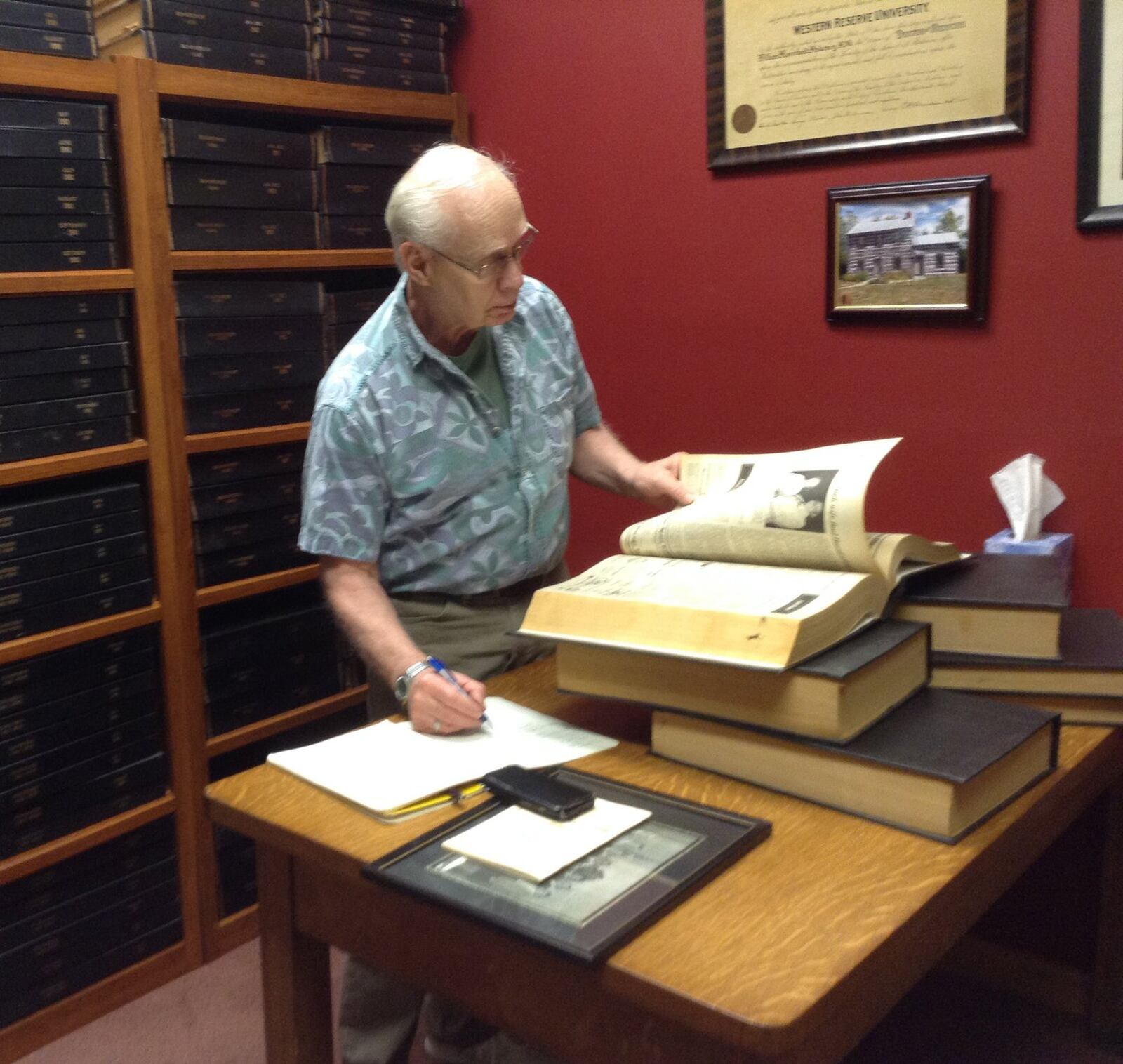 David Shumway goes through bound copies of the Beavercreek News in archive section of the Beavercreek Historical Society’s new History Center as he researched his history of Beavercreek. CONTRIBUTED