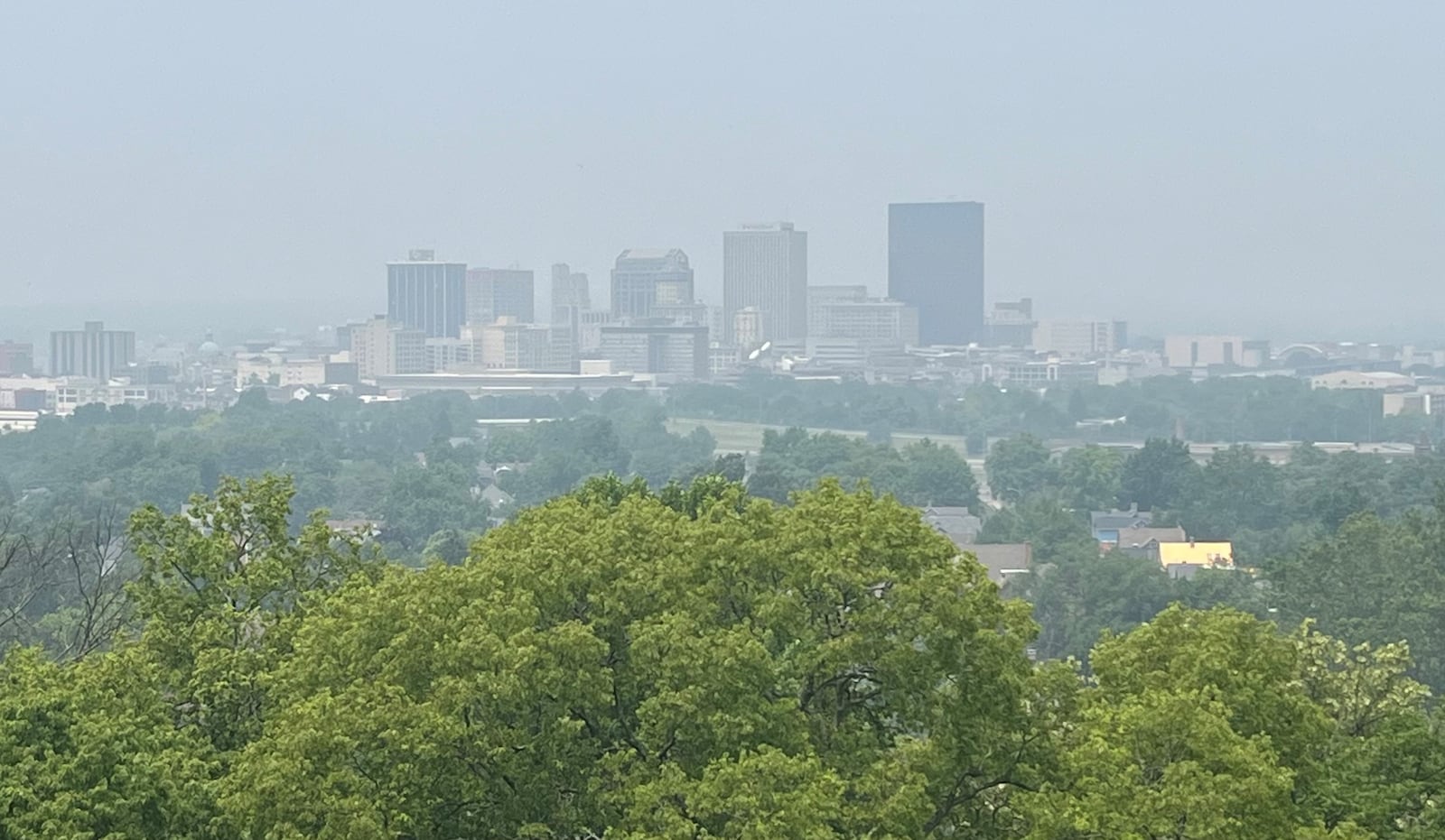 The downtown Dayton skyline is seen through a hazy smoke from Canadian wildfires on Wednesday, June 28, 2023. JEREMY P. KELLEY / STAFF