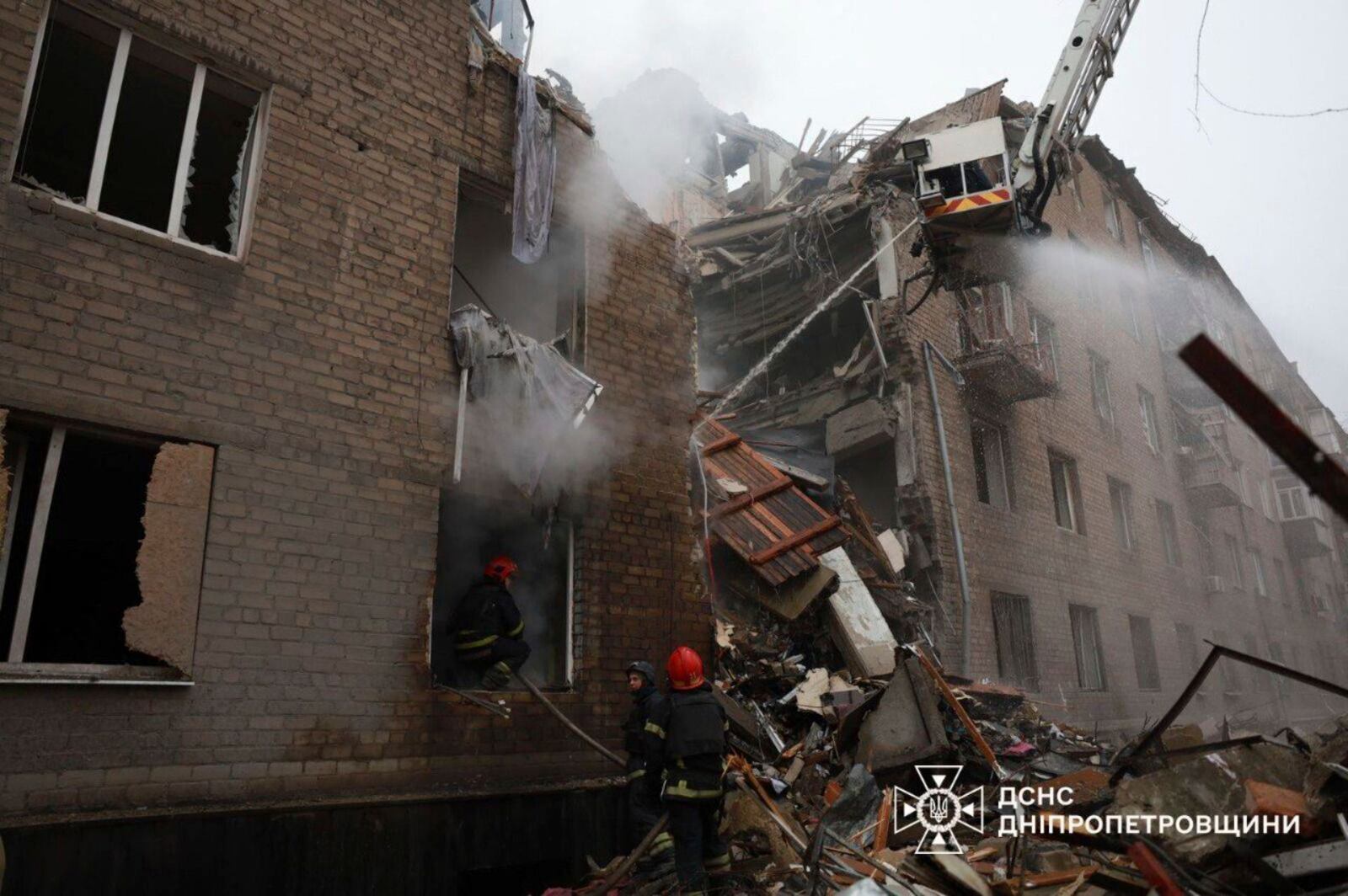 In this image provided by the Ukrainian Emergency Service on Monday, Nov. 11, 2024, firefighters work on a site of an apartments building destroyed by a Russian attack in Kryvyi Rih, Ukraine. (Ukrainian Emergency Service via AP)