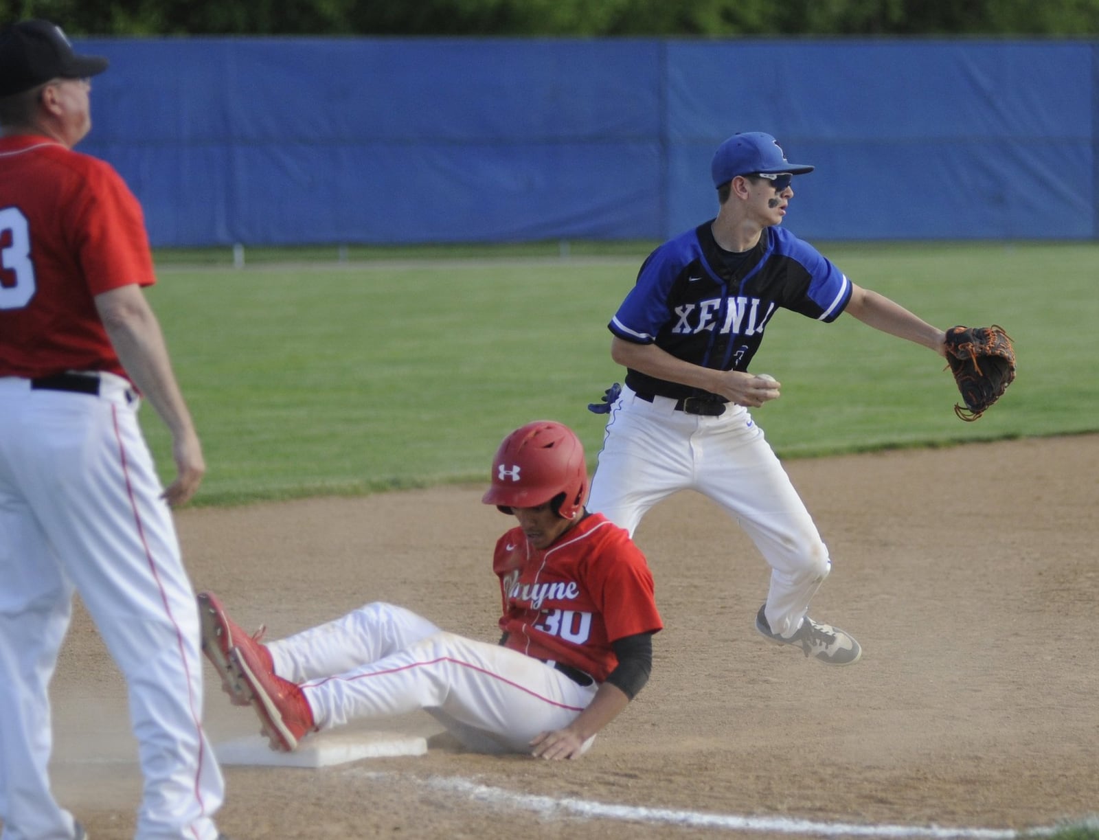 Wayne’s Cameron Walker (sliding) was tagged out by Xenia third baseman Aaron Adkins. Wayne defeated host Xenia 6-3 in a D-I sectional opener on Wednesday, May 14, 2019. MARC PENDLETON / STAFF