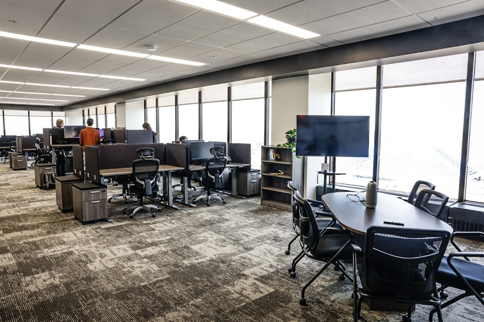 Workers enjoy an open workspace at Tenet3 in the Stratacache Tower in Dayton. JIM NOELKER/STAFF