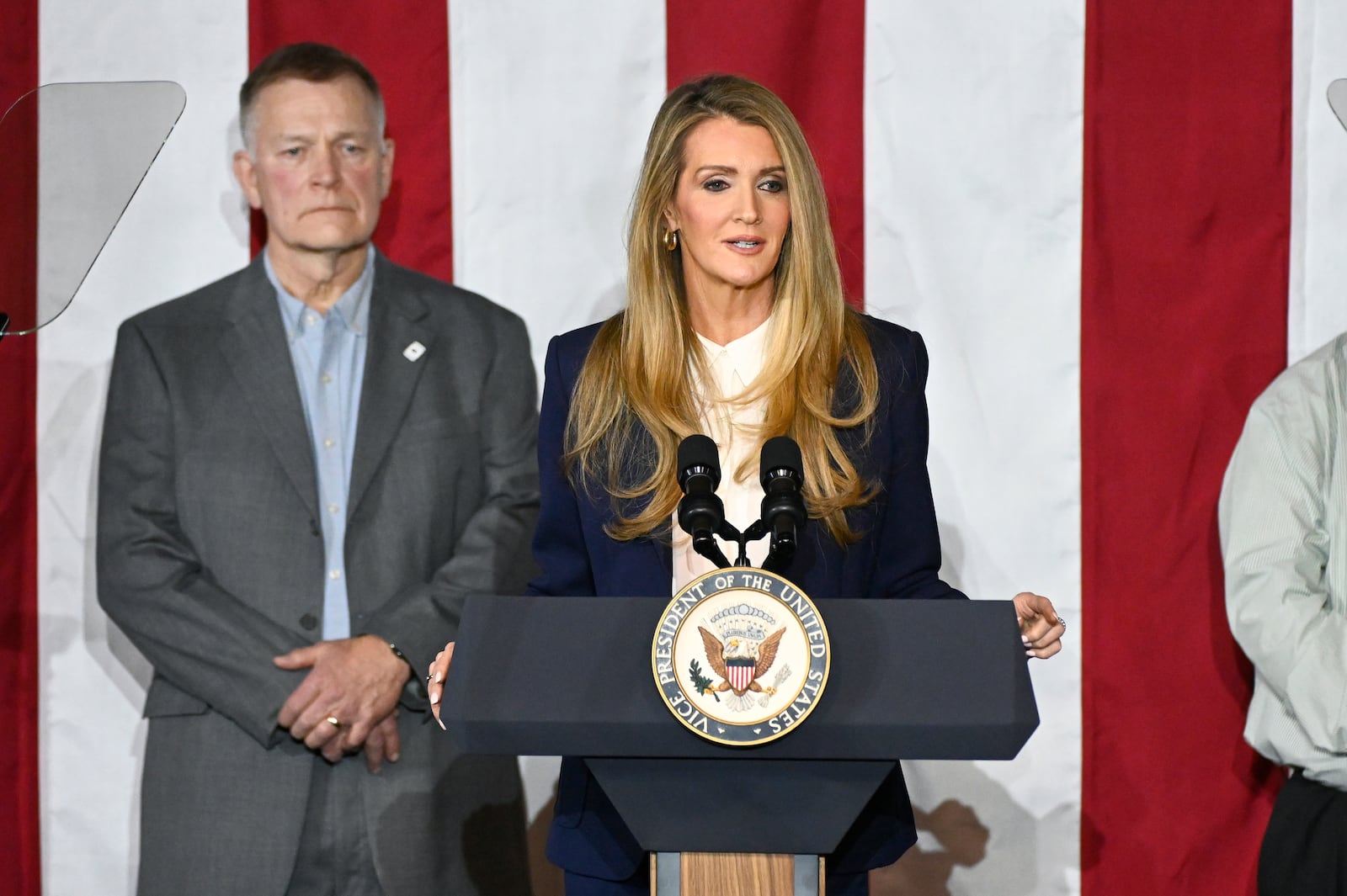 Administrator of the Small Business Administration Kelly Loeffler, right, speaks at a rally before Vice President JD Vance speaks about "America's industrial resurgence," Friday, March 14, 2025, at Vantage Plastics in Bay City, Mich. At left is Vantage Plastics President Paul Aultman. (AP Photo/Jose Juarez)