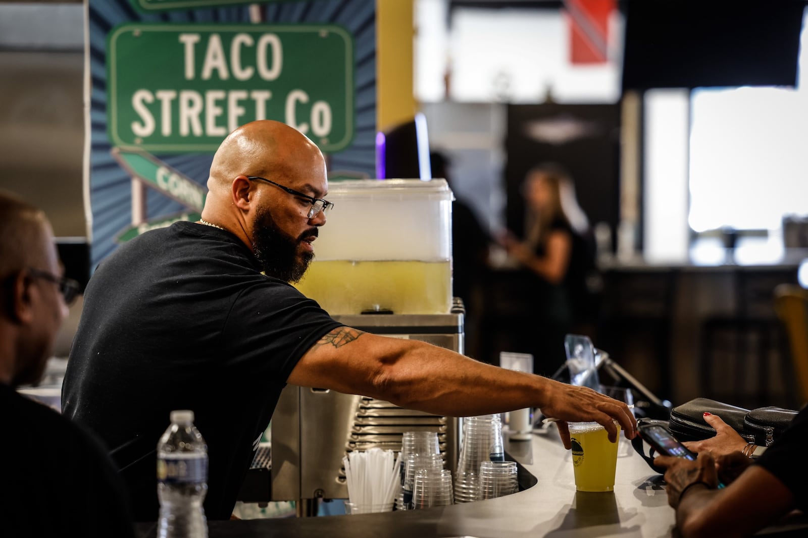 Taco Street Co. owner, Anthony Thomas fixes drinks at his store inside West Social Tap and Table at 1100 West Third St. JIM NOELKER/STAFF