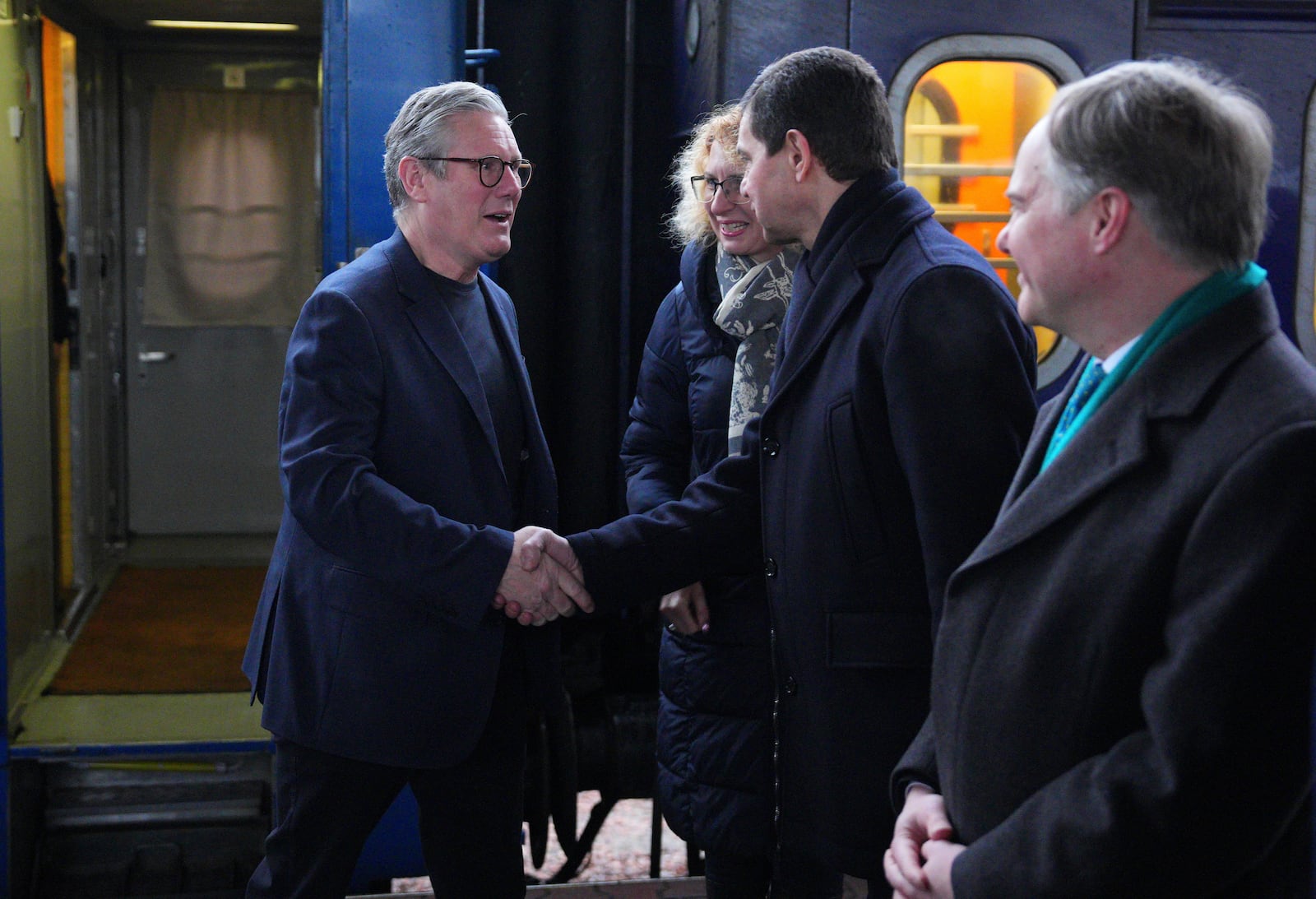 British Prime Minister Keir Starmer, left, is greeted by Ukrainian officials and the British ambassador to Ukraine Martin Harris, right, as he arrives at a train station in Kyiv, Ukraine Thursday, Jan. 16, 2025. (Carl Court/Pool Photo via AP)