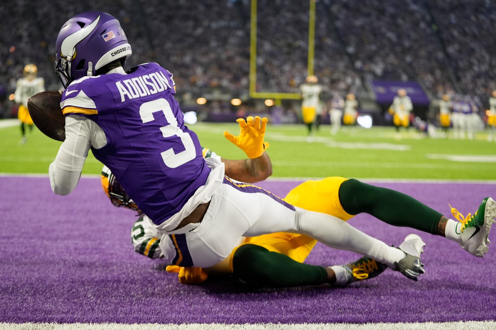 Green Bay Packers' Keisean Nixon breaks up a pass intended for Minnesota Vikings' Jordan Addison during the first half of an NFL football game Sunday, Dec. 29, 2024, in Minneapolis. (AP Photo/Abbie Parr)