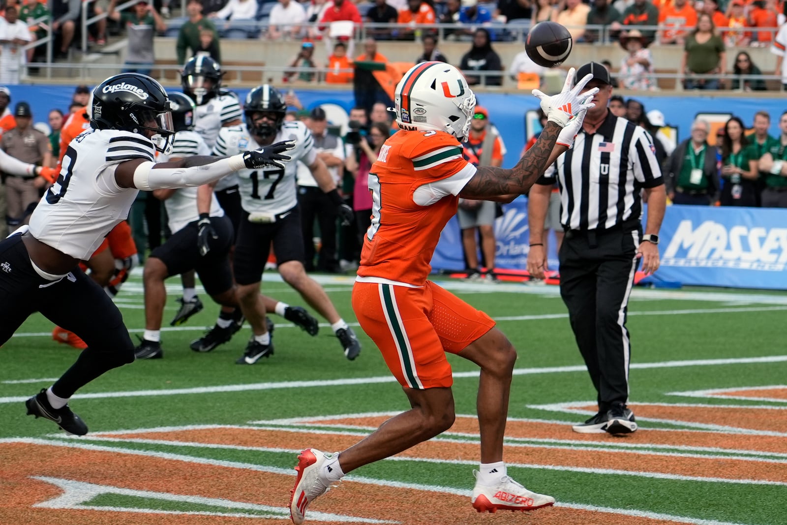 Miami wide receiver Jacolby George, right, makes a catch for a touchdown in front of Iowa State defensive back Ta'Shawn James during the first half of the Pop Tarts Bowl NCAA college football game, Saturday, Dec. 28, 2024, in Orlando, Fla. (AP Photo/John Raoux)