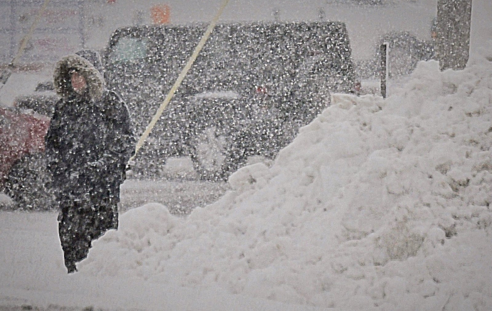 As snow piles up this man waits for the bus on Woodman Avenue. MARSHALL GORBY/STAFF