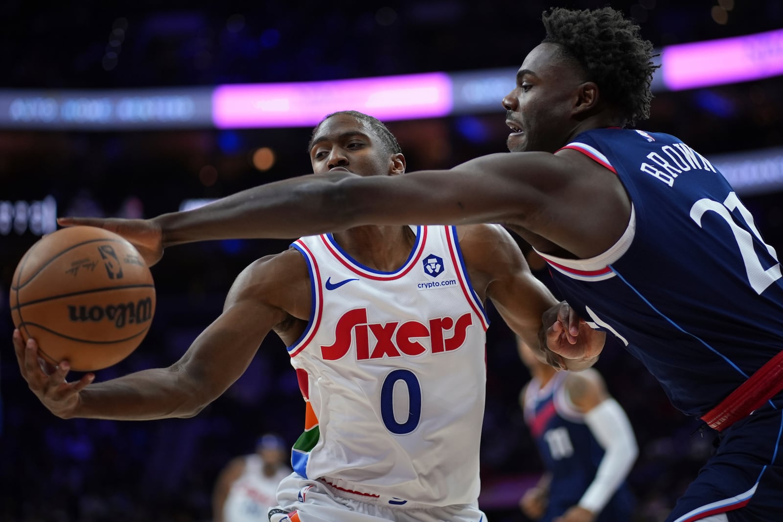 Philadelphia 76ers' Tyrese Maxey (0) and Los Angeles Clippers' Kobe Brown (21) reach for a loose ball during the second half of an NBA basketball game, Sunday, Nov. 24, 2024, in Philadelphia. (AP Photo/Matt Slocum)