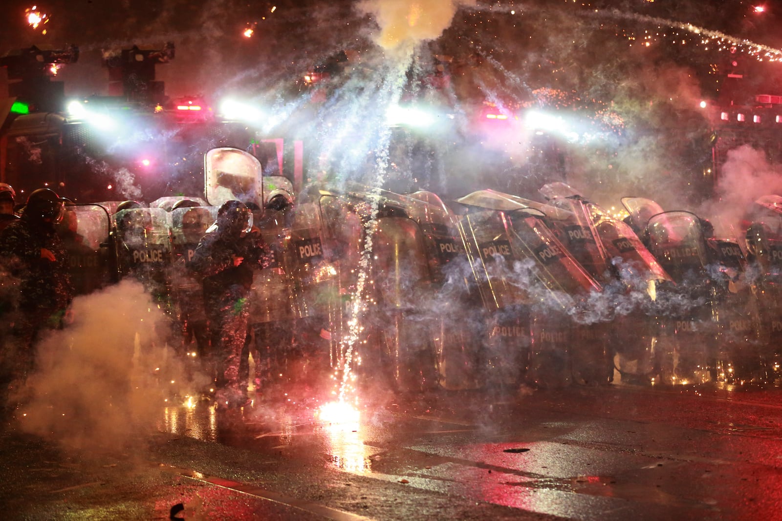 Demonstrators launch firecrackers into the police during a rally to protest against the government's decision to suspend negotiations on joining the European Union in Tbilisi, Georgia, on Tuesday, Dec. 3, 2024. (AP Photo/Zurab Tsertsvadze)