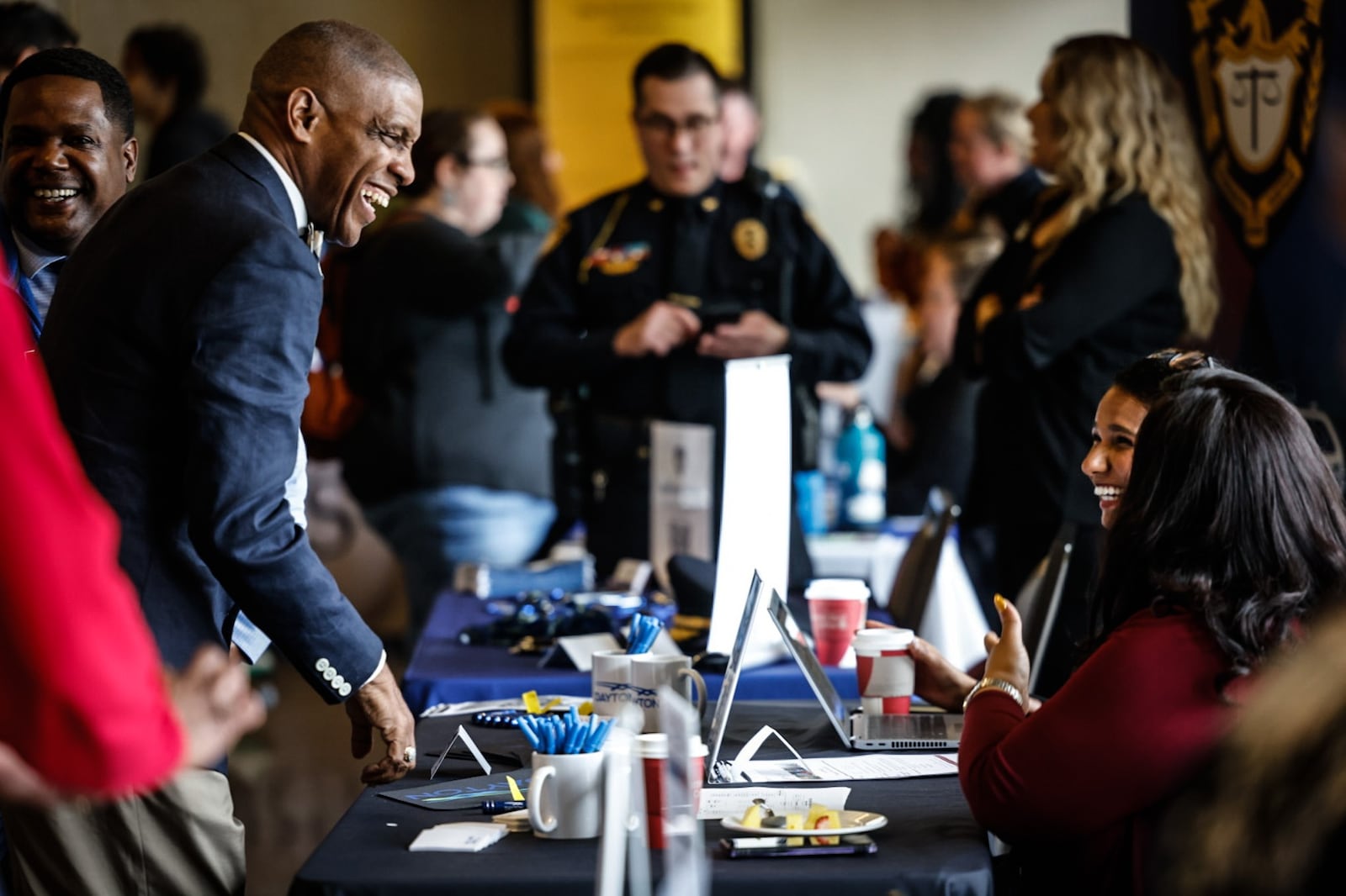 Dayton Public Schools employee Gary Armstrong, left talks with representatives from the city of Dayton on Wednesday April 10, 2024. Sinclair hosted the job fair, which attracted near 100 employers. JIM NOELKER/STAFF