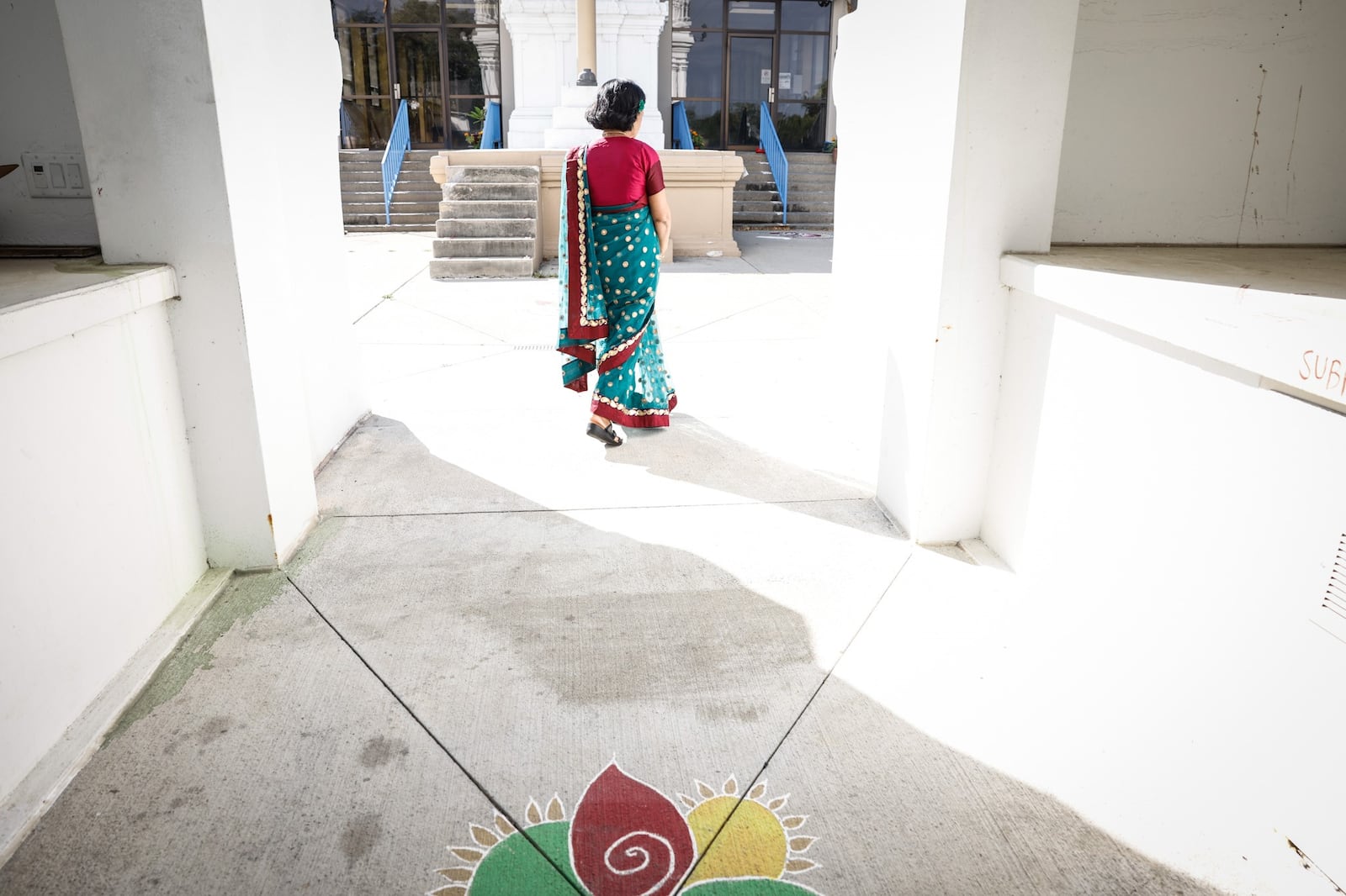 Sunita Agarwal walks through the gateway to the Hindu Temple of Dayton. JIM NOELKER/STAFF