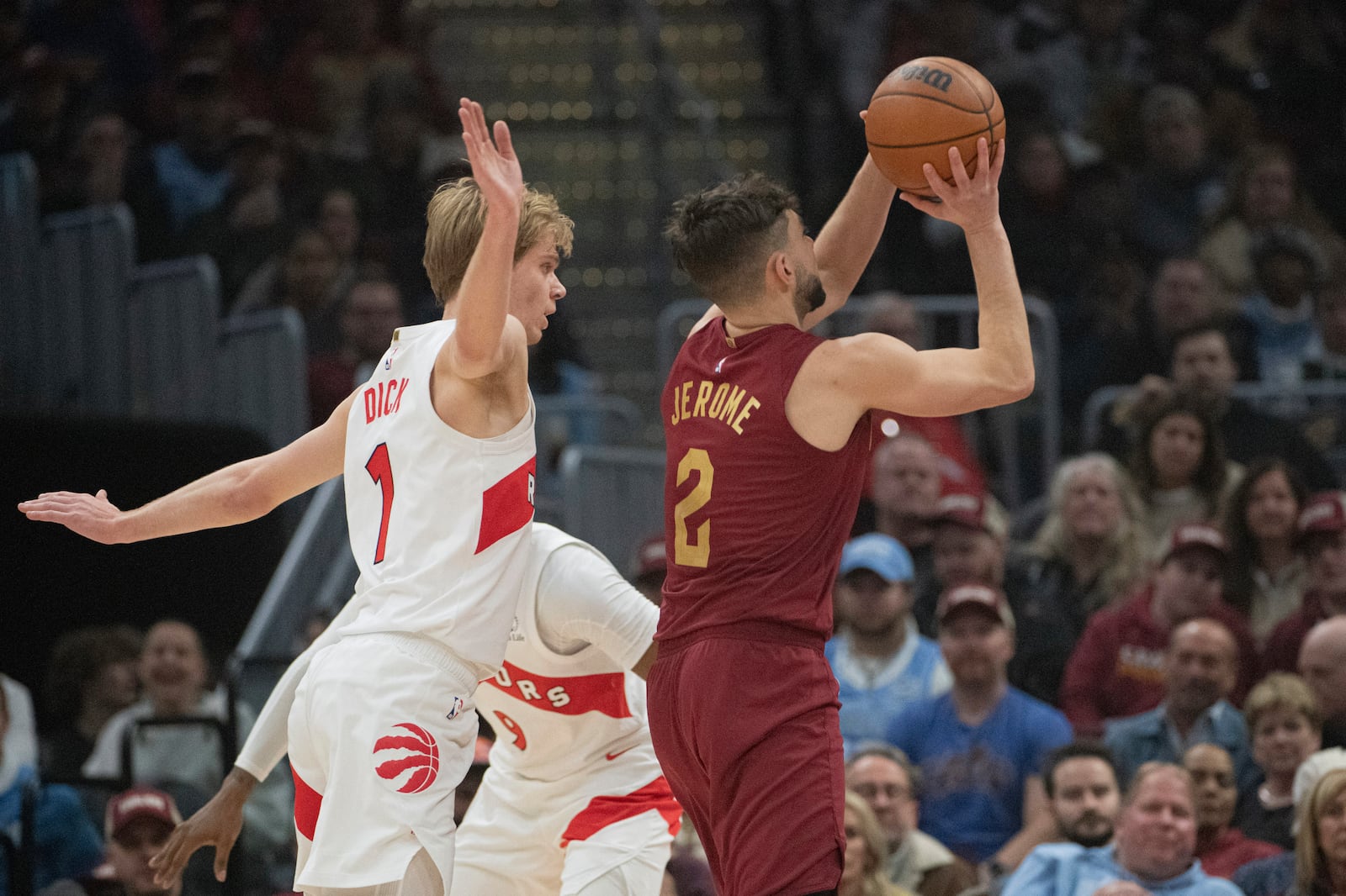 Cleveland Cavaliers' Ty Jerome (2) shoots as Toronto Raptors' Gradey Dick (1) backs away during the first half of an NBA basketball game in Cleveland, Thursday, Jan. 9, 2025. (AP Photo/Phil Long)