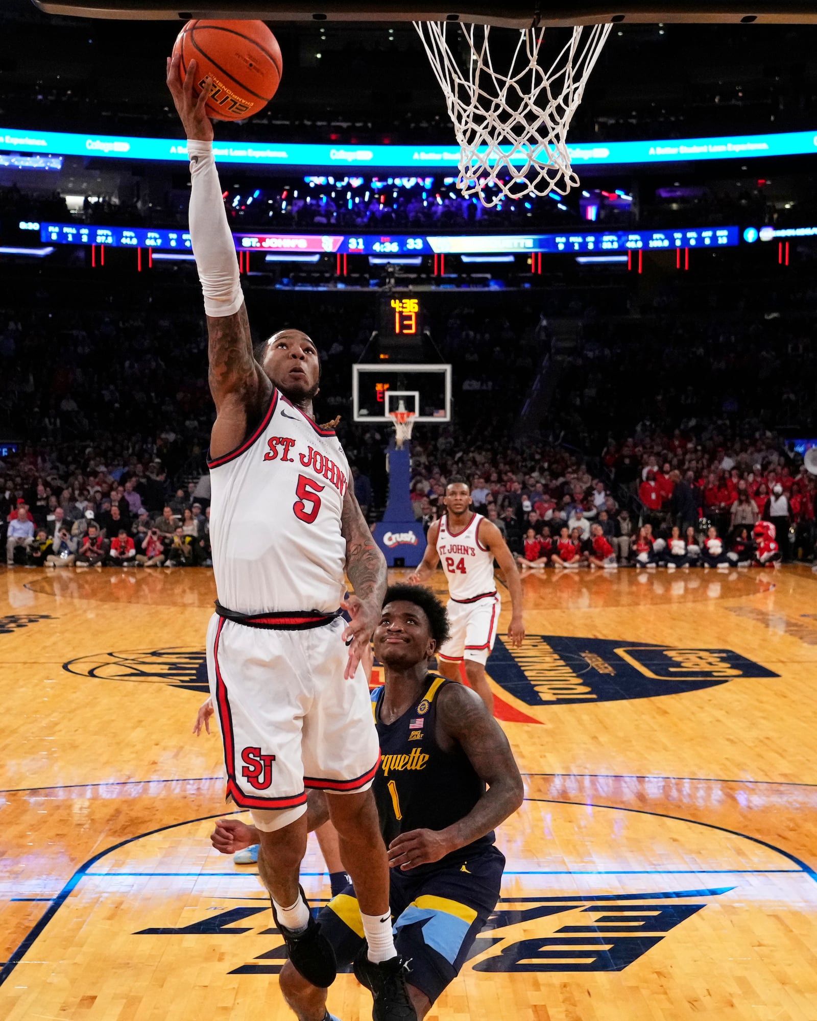 St. John's's Deivon Smith (5) drives past Marquette's Kam Jones (1) during the first half of an NCAA college basketball game in the semifinals of the Big East tournament Friday, March 14, 2025, in New York. (AP Photo/Frank Franklin II)