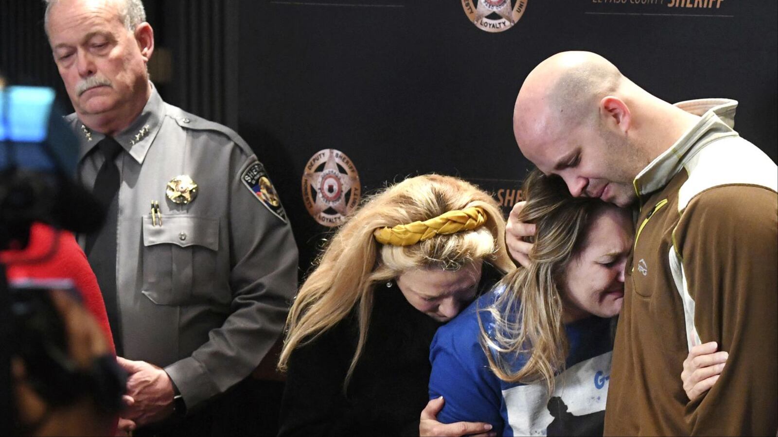 Al Stauch, far right, holds his ex-wife, Landen Hiott, Monday, March 2, 2020, during a news conference about the disappearance and presumed slaying of their son, 11-year-old Gannon Stauch, in Colorado Springs, Colo. Al Stauch's second wife, Letecia Stauch, has been charged with murder and related charges in the death of the boy, who she reported missing Jan. 27.