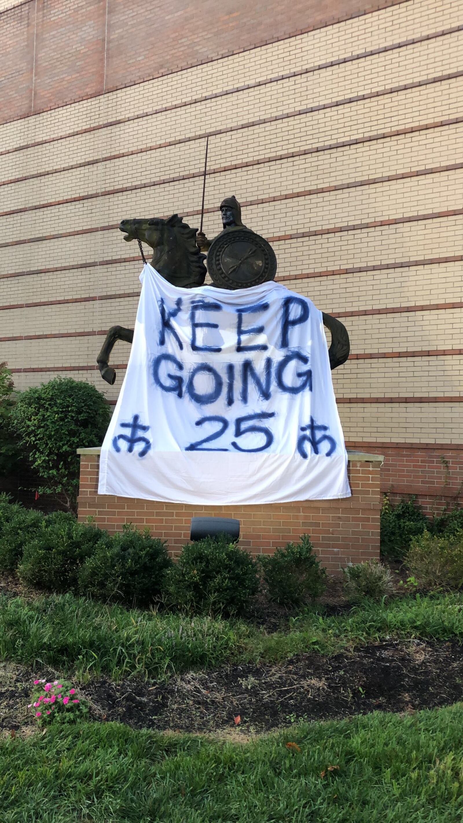 The Crusader statute at Moeller High School with the rallying cry honoring Michael Currin. CONTRIBUTED