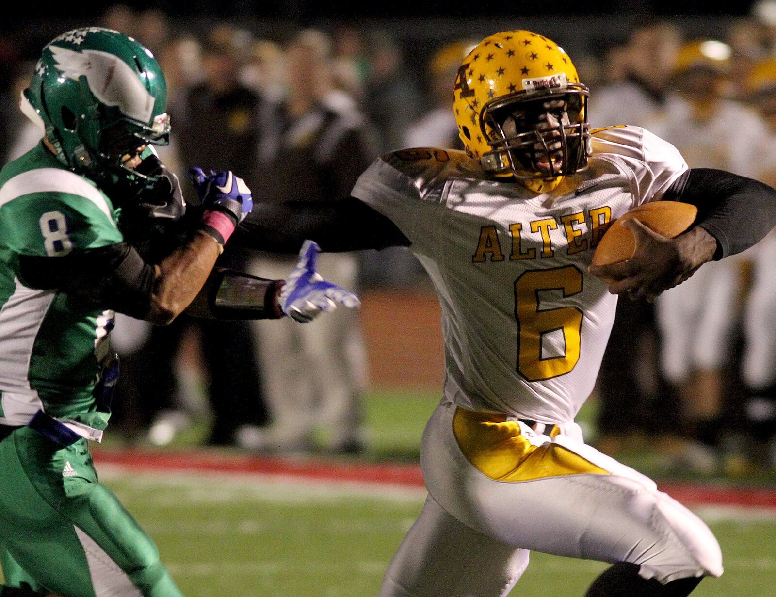 E.L. Hubbard photography Alter quarterback Malik Zaire eludes CJ defensive back Darian Reynolds in the first half at Trotwood-Madison Friday, Oct. 28, 2011.