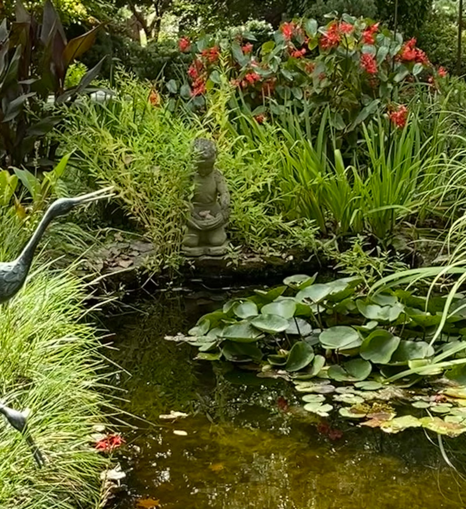 Statuary and stonework blend into the unique combination of water-loving plants plus fish, frogs and turtles. CONTRIBUTED