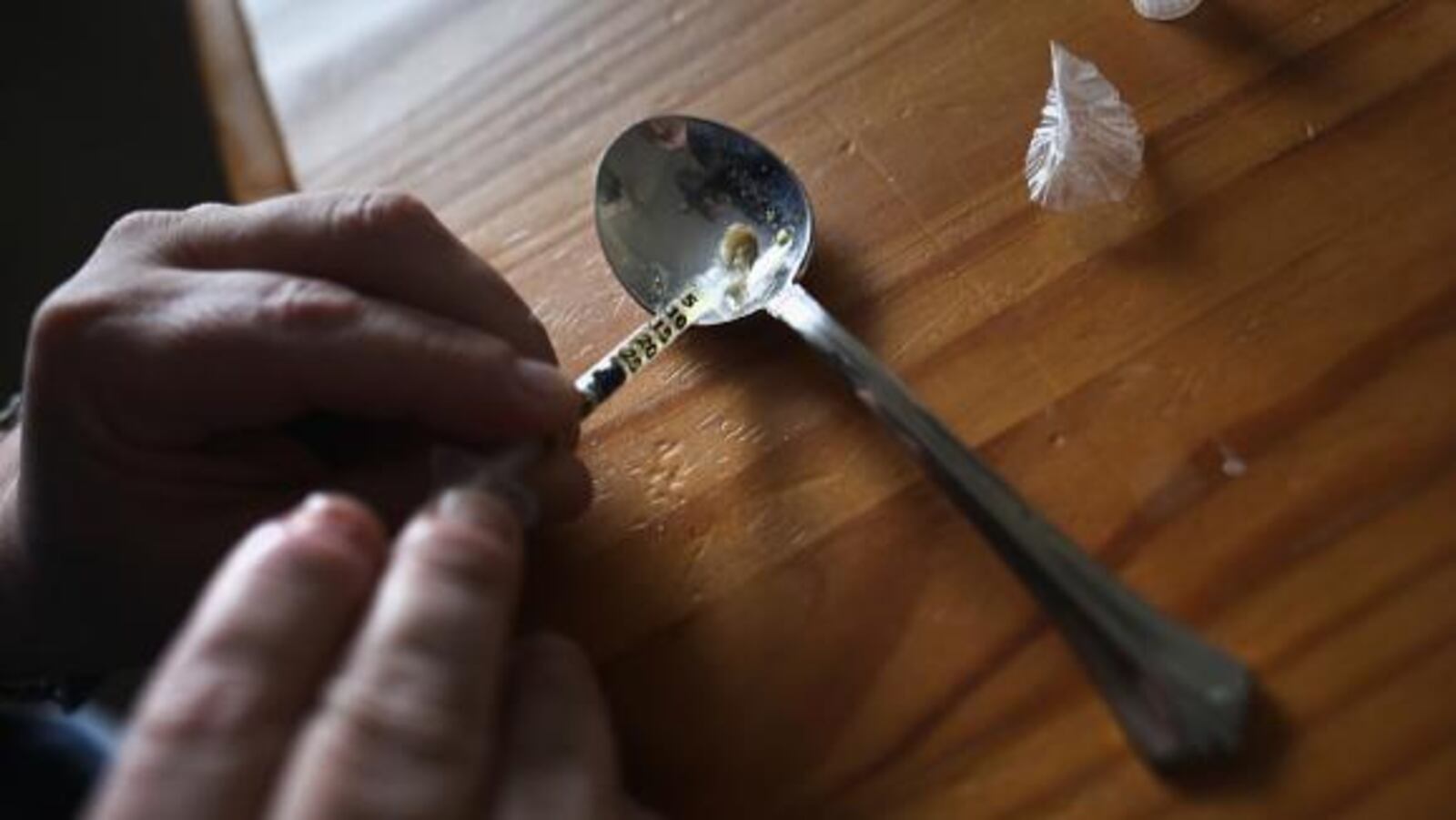 NEW LONDON, CT - MARCH 23:  A heroin user prepares to inject himself on March 23, 2016 in New London, CT. Communities nationwide are struggling with the unprecidented heroin and opioid pain pill epidemic. On March 15, the U.S. Centers for Disease Control (CDC), announced guidelines for doctors to reduce the amount of opioid painkillers prescribed nationwide, in an effort to curb the epidemic. The CDC estimates that most new heroin addicts first became hooked on prescription pain medication before graduating to heroin, which is stronger and cheaper.  (Photo by John Moore/Getty Images)