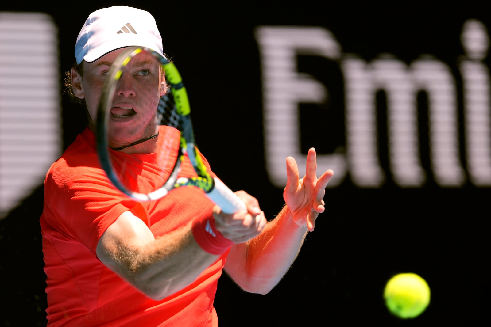 Alex Michelsen of the U.S. plays a forehand return to Stefanos Tsitsipas of Greece during their first round match at the Australian Open tennis championship in Melbourne, Australia, Monday, Jan. 13, 2025. (AP Photo/Ng Han Guan)