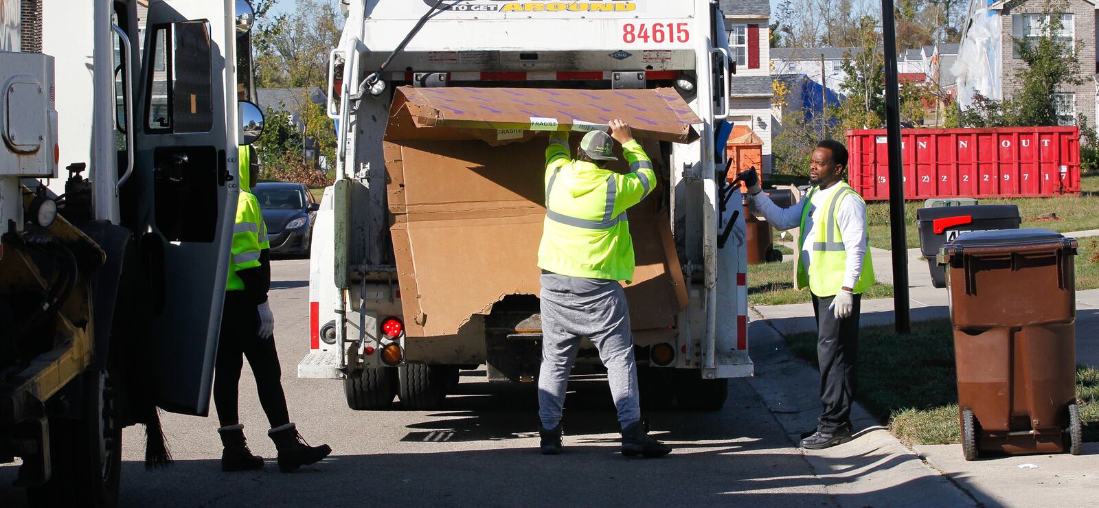 A recycling truck picks up large boxes that held construction materials during pickup in Trotwood's Wolf Creek Run, a hard-hit subdivision where rebuilding or demolition has proceeded rapidly compared to some other areas. CHRIS STEWART / STAFF