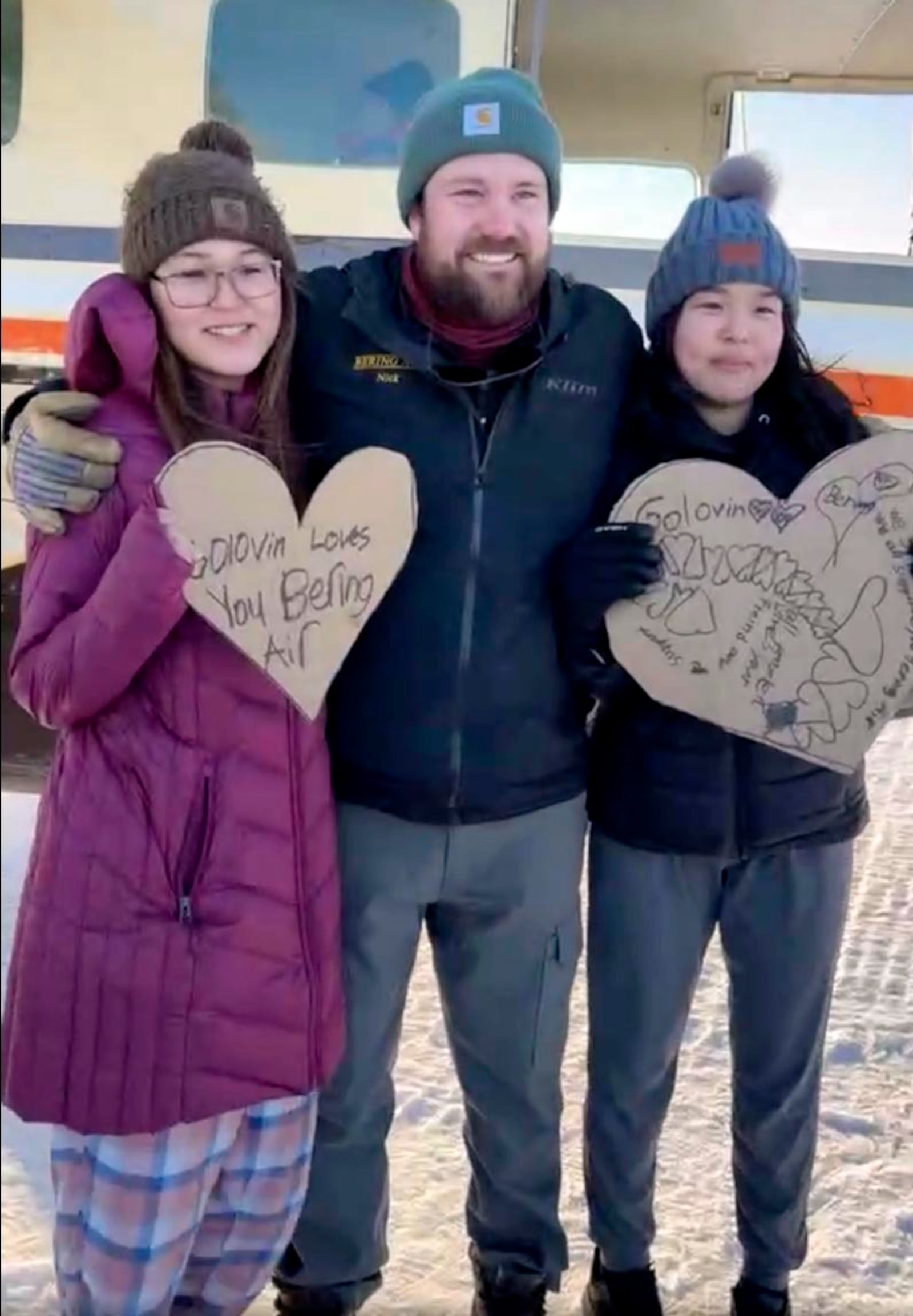 In this screen grab from a Facebook livestream, residents from the Inupiat Eskimo village of Golovin in Alaska pose with a Bering Air pilot, Saturday, Feb. 8, 2025. (AP via Irene Navarro)