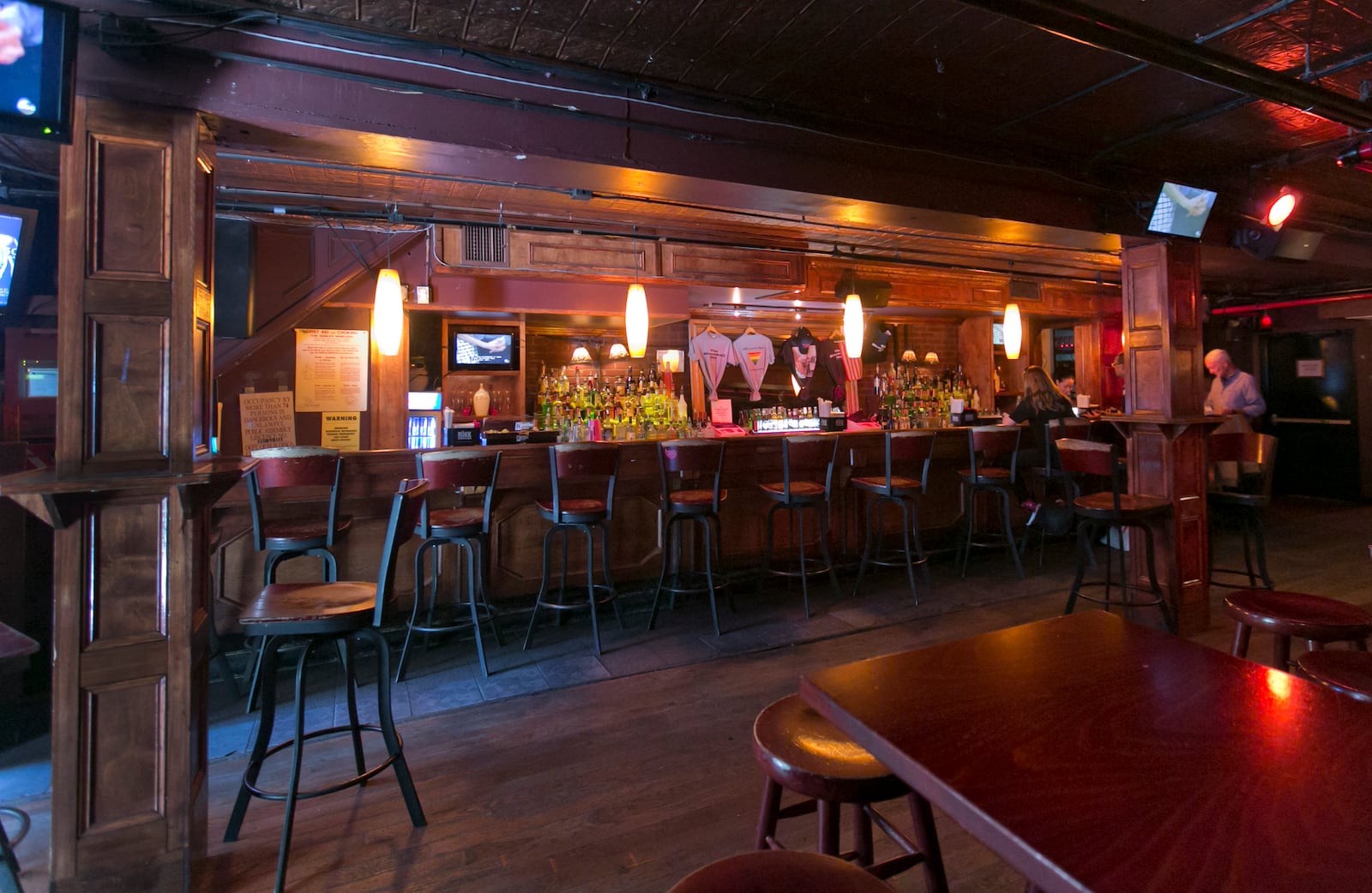 FILE - Patrons sit at the bar in The Stonewall Inn, in New York's Greenwich Village, Thursday, May 29, 2014. (AP Photo/Richard Drew, File)