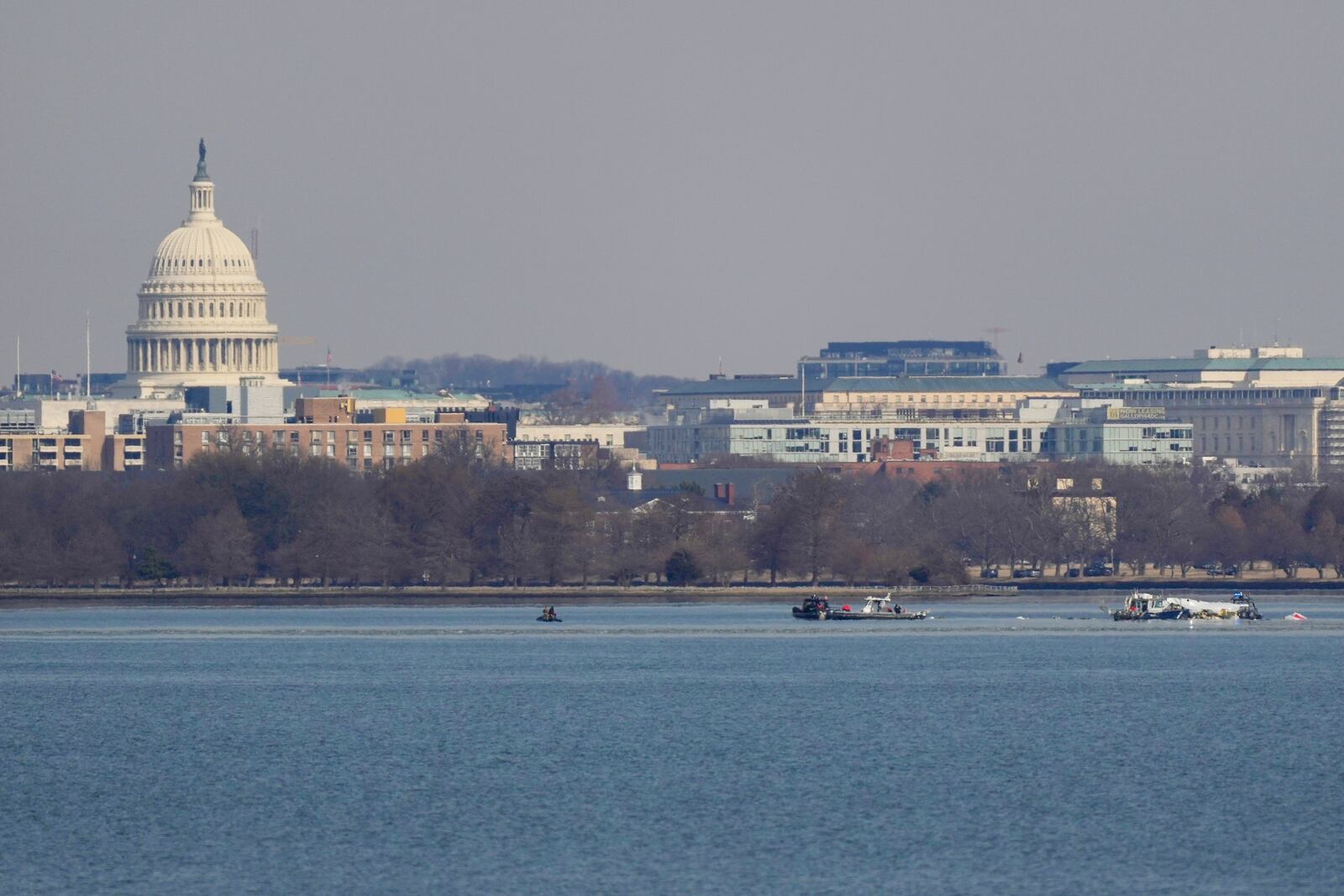 Search and rescue efforts are seen around a wreckage site in the Potomac River from Ronald Reagan Washington National Airport, early Thursday morning, Jan. 30, 2025, in Arlington, Va. (AP Photo/Carolyn Kaster)