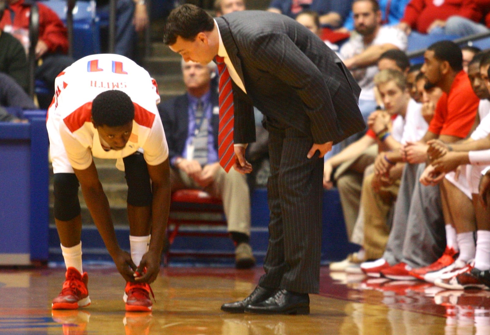 Dayton coach Archie Miller talks to guard Scoochie Smith on Saturday, Oct. 26, 2013, at UD Arena. David Jablonski/Staff