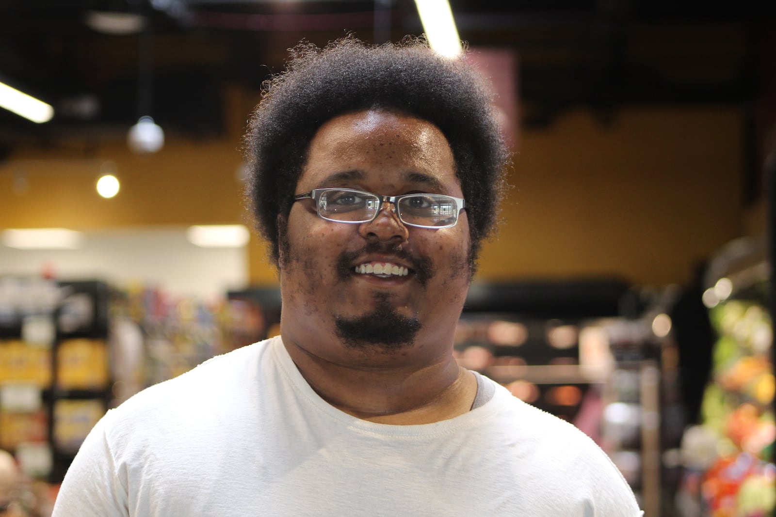 Kirk Davis, 28, filled out a form on Wednesday at the Gem City Market to participate in the Produce Perks program. CORNELIUS FROLIK / STAFF