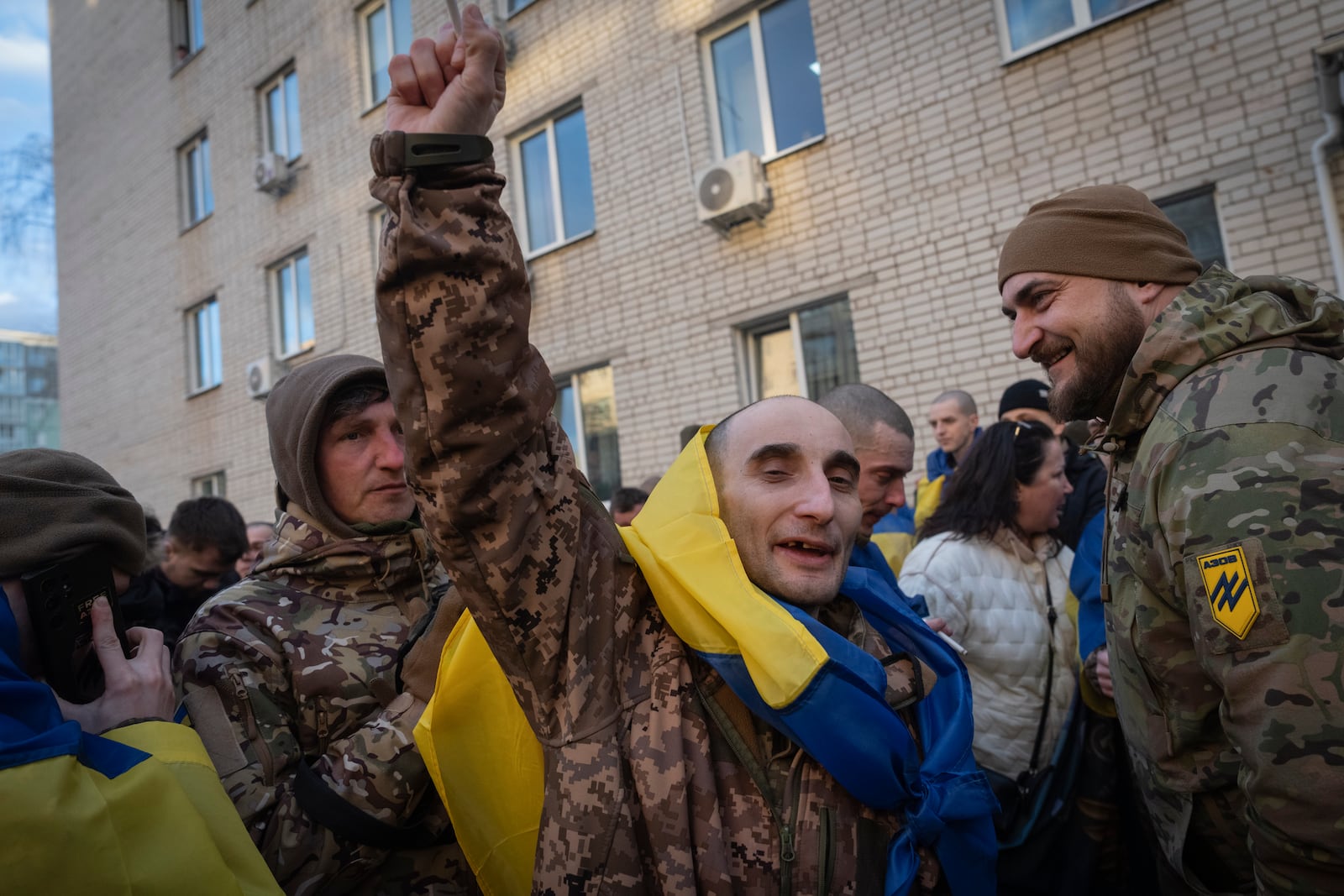 A Ukrainian serviceman reacts after returning from captivity during a POWs exchange between Russia and Ukraine, in Chernyhiv region, Ukraine, Wednesday, March 19, 2025. (AP Photo/Efrem Lukatsky)