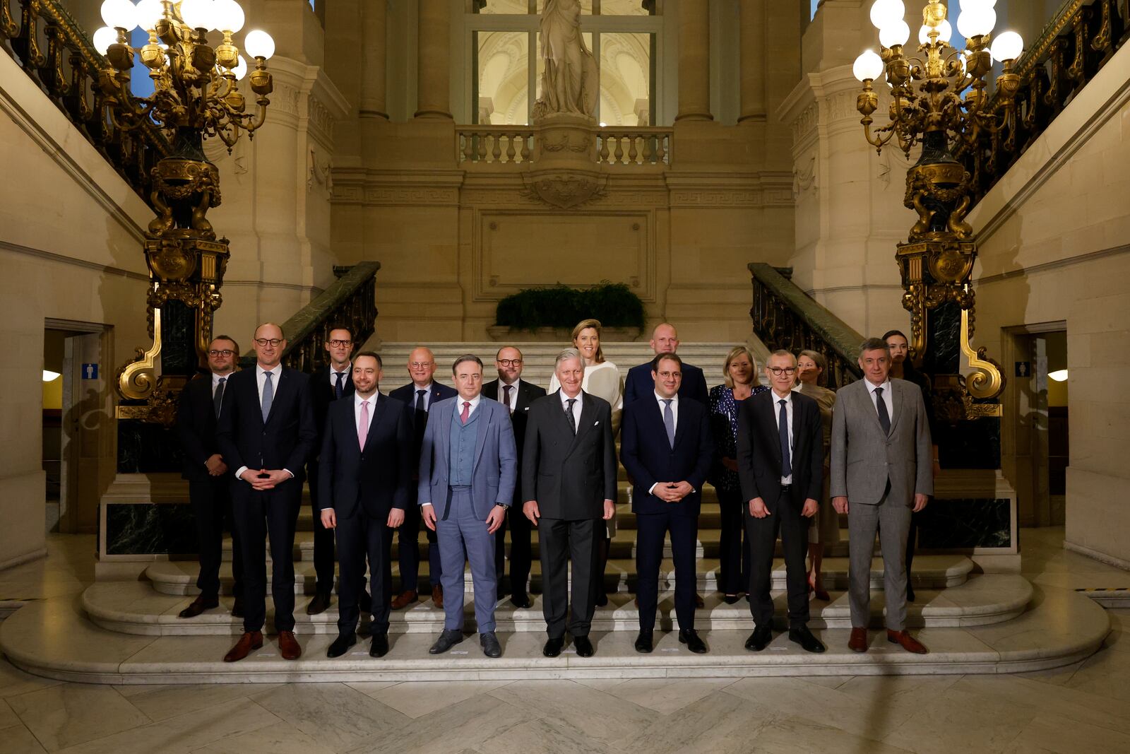 Belgium's King Philippe, center front, and new Belgian Prime Minister Bart De Wever, front center left, pose with ministers for a group photo after a swearing in ceremony for the new government at the Royal Palace in Brussels, Monday, Feb. 3, 2025. (AP Photo/Omar Havana)