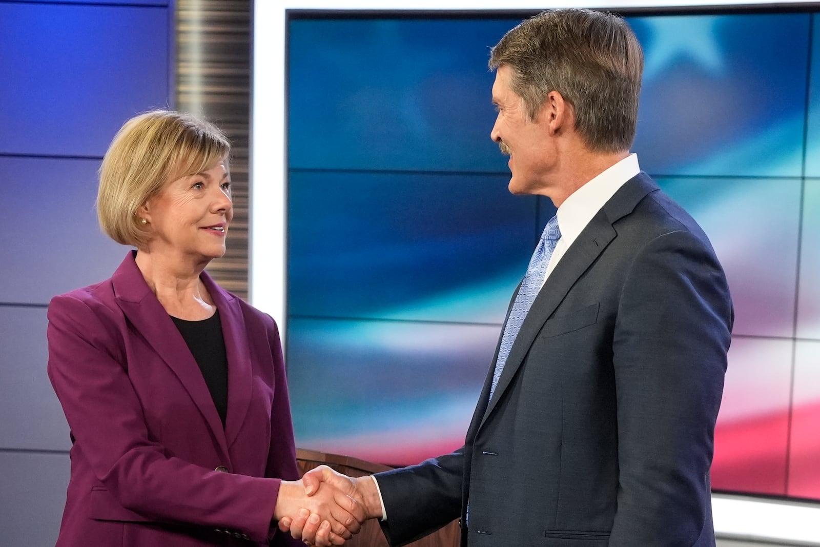 Wisconsin Senate candidates Republican Eric Hovde and Democratic U.S. Sen. Tammy Baldwin shake hands before a televised debate Friday, Oct. 18, 2024, in Madison, Wis. (AP Photo/Morry Gash)