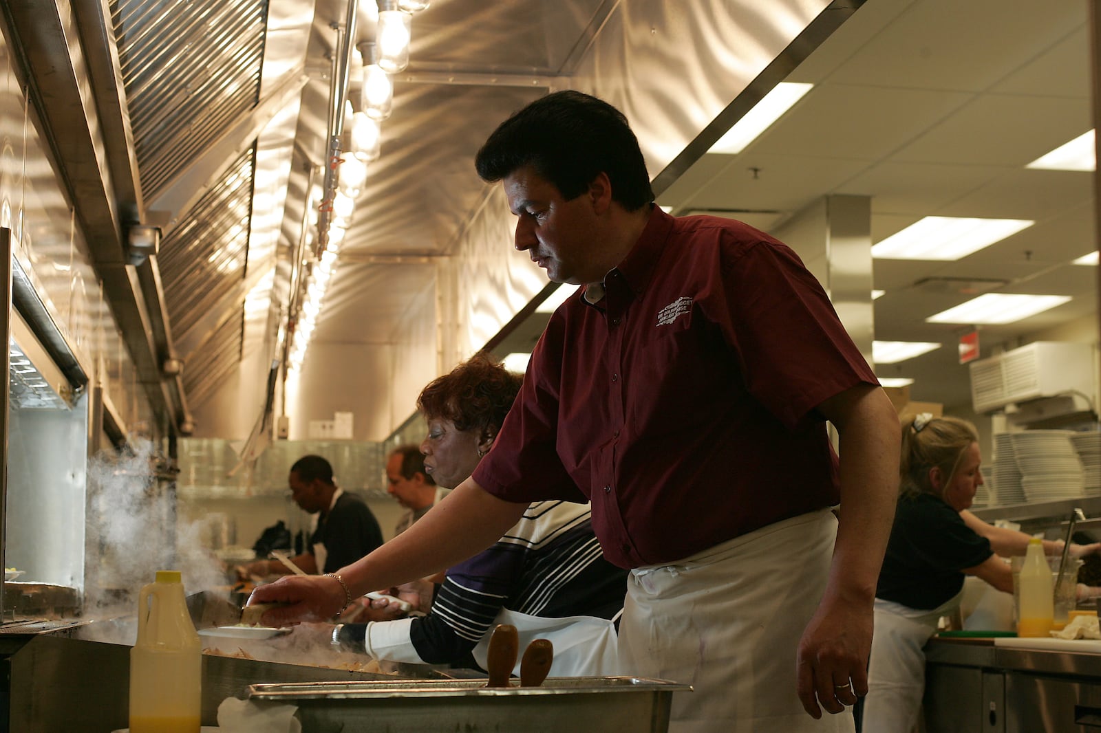 Pantalis Frangomichalos, owner of the Golden Nugget Pancake House, cooks potatoes on opening day in April 2005. The Dayton landmark had burned down 18 months earlier FILE PHOTO