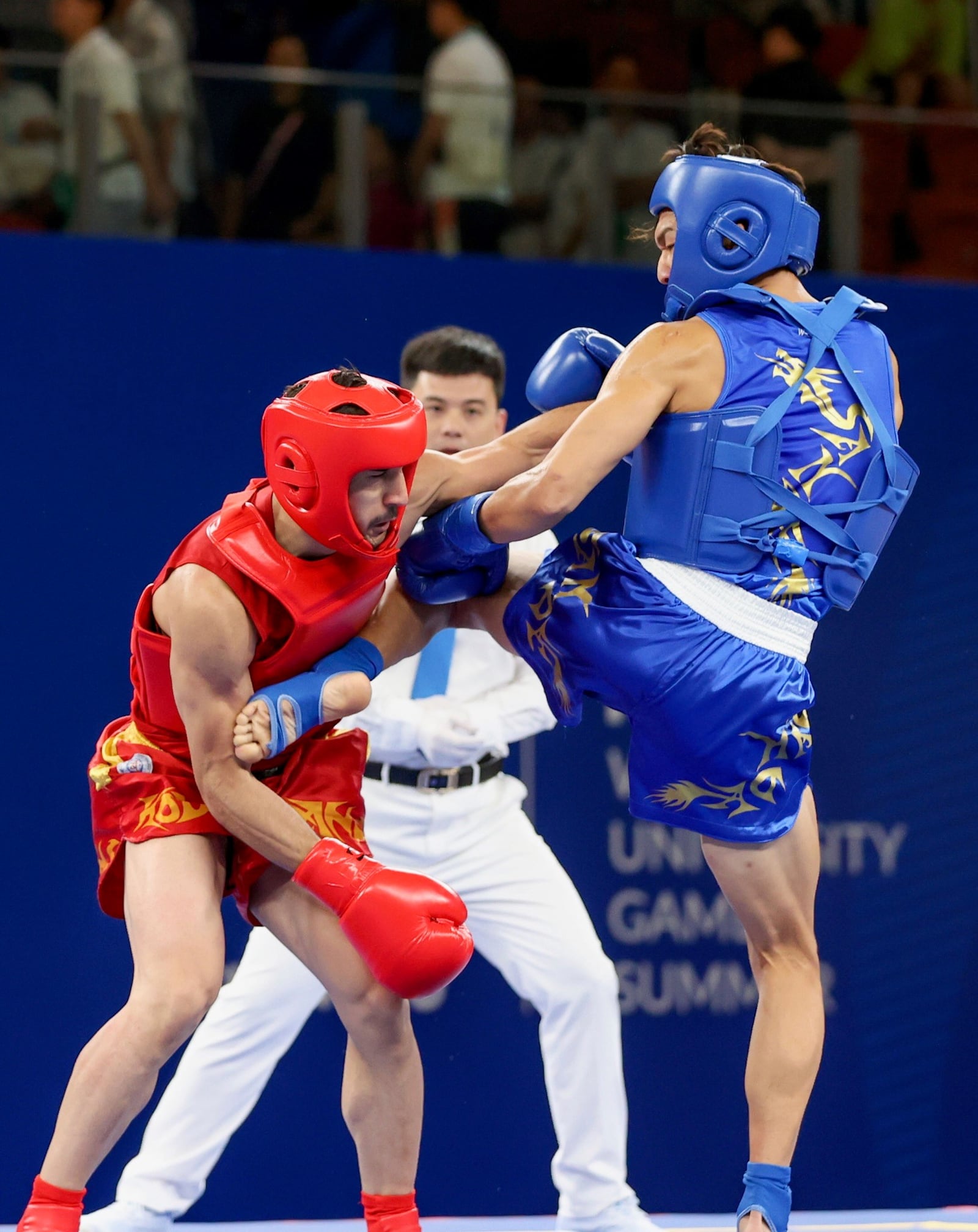 Vincent Meng (blue) competes againsat Iranian Hamidreza Sahandi at the 31st World University Games in Chengdu, China earlier this month. CONTRIBUTED