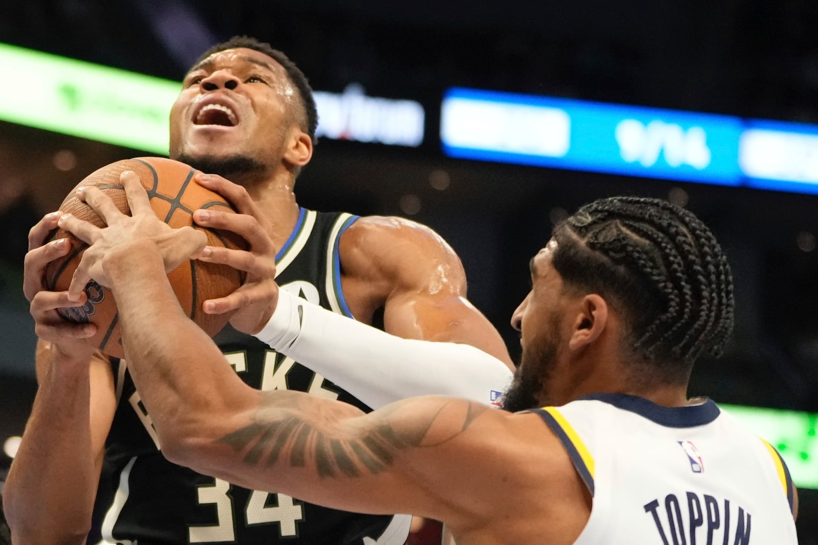 Indiana Pacers' Obi Toppin ties up Milwaukee Bucks' Giannis Antetokounmpo during the first half of an Emirates NBA cup tournament basketball game Friday, Nov. 22, 2024, in Milwaukee. (AP Photo/Morry Gash)