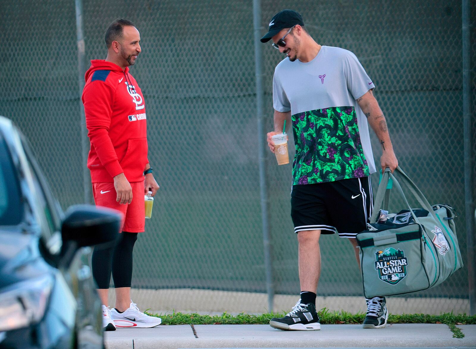 St. Louis Cardinals infielder Nolan Arenado, right, is greeted by manager Oliver Marmol on Sunday, Feb. 16, 2025, at the team's spring training baseball facility in Jupiter, Fla. (Christian Gooden/St. Louis Post-Dispatch via AP)