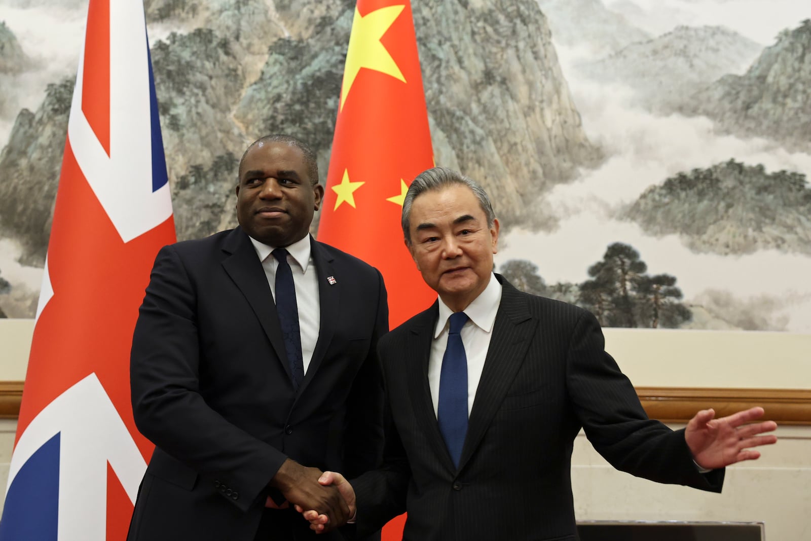 Britain's Foreign Secretary David Lammy and Chinese Foreign Minister Wang Yi shake hands before their meeting at the Diaoyutai State Guesthouse in Beijing, China, Friday, Oct. 18, 2024. (Florence Lo/Pool Photo via AP)