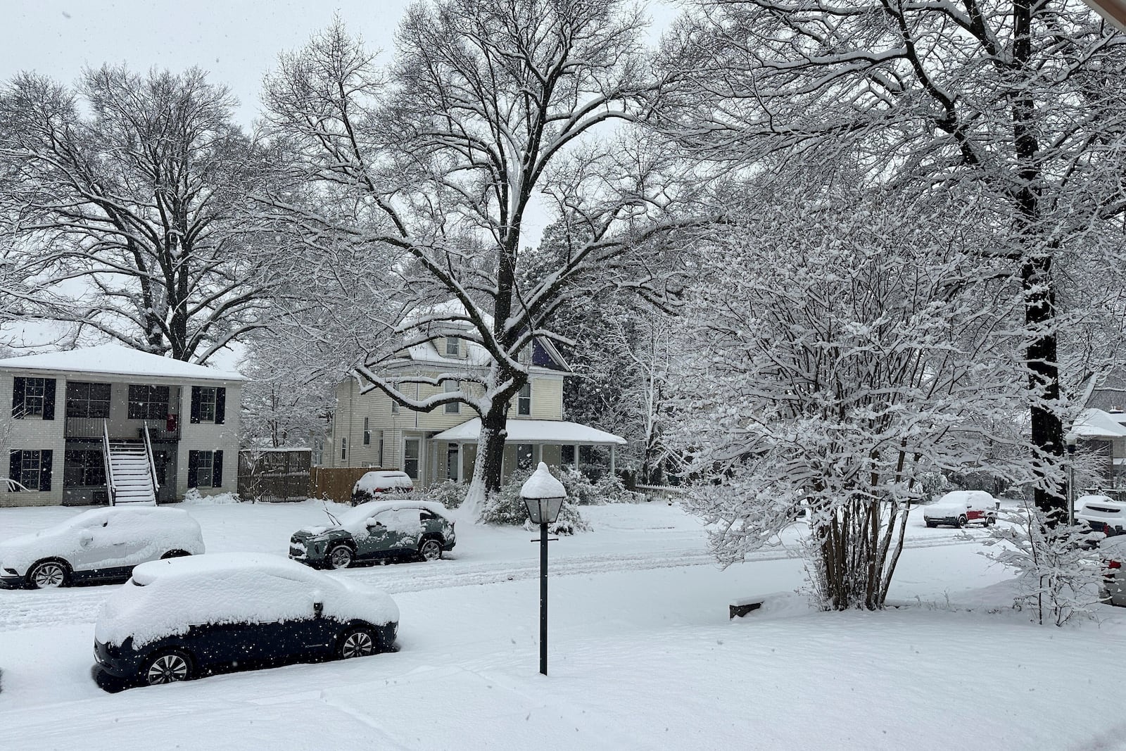 Snow blankets a street in Memphis, Tennessee, Friday, Jan. 10, 2025. (AP Photo/Adrian Sainz)