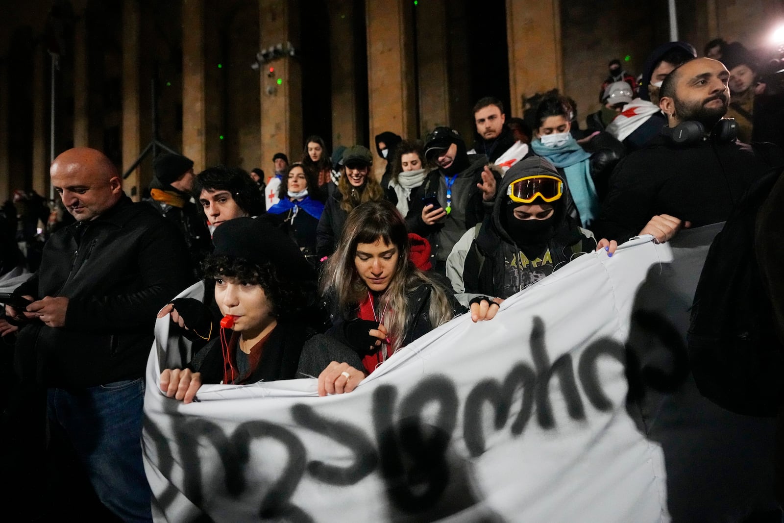 Demonstrators gather to continue protest against the government's decision to suspend negotiations on joining the European Union outside the parliament's building in Tbilisi, Georgia, on Tuesday, Dec. 3, 2024. (AP Photo/Pavel Bednyakov)