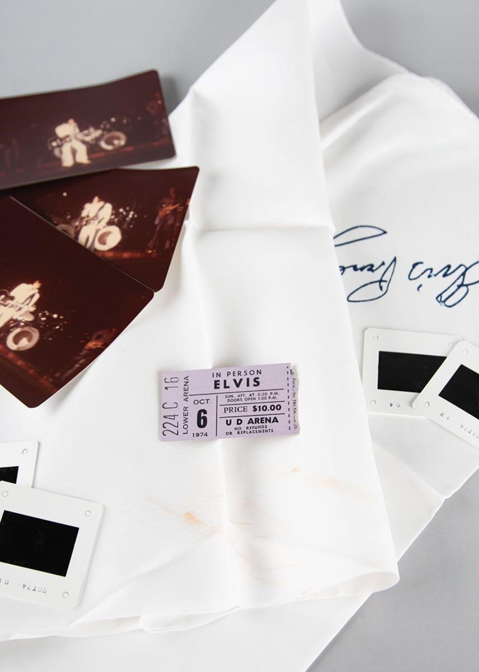 An assortment of items pertaining to Elvis Presley's career, including a vintage white silk scarf attested to as being worn by Presley in 1974 at the University of Dayton Arena, are on the auction block. CONTRIBUTED