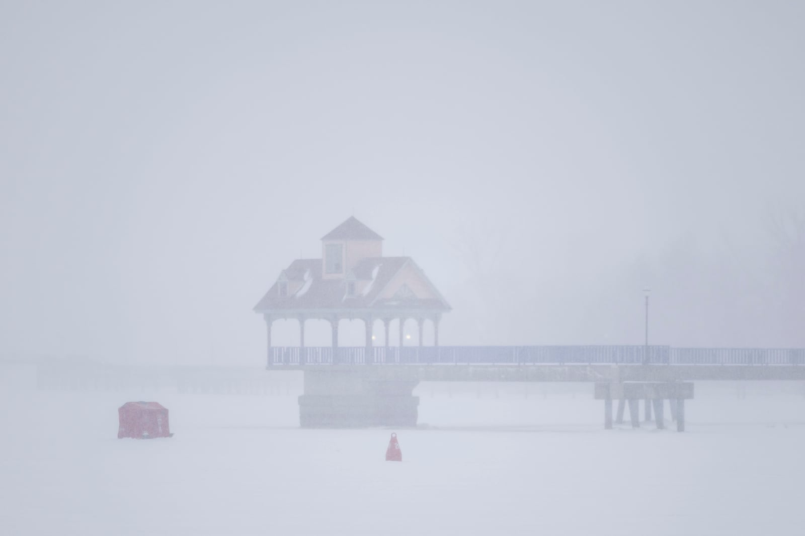 An ice shanty is set up on Saginaw River as a snowstorm rolls in on Wednesday, Feb. 12, 2025, in Bay City, Mich. (Kaytie Boomer/MLive.com/The Bay City Times via AP)