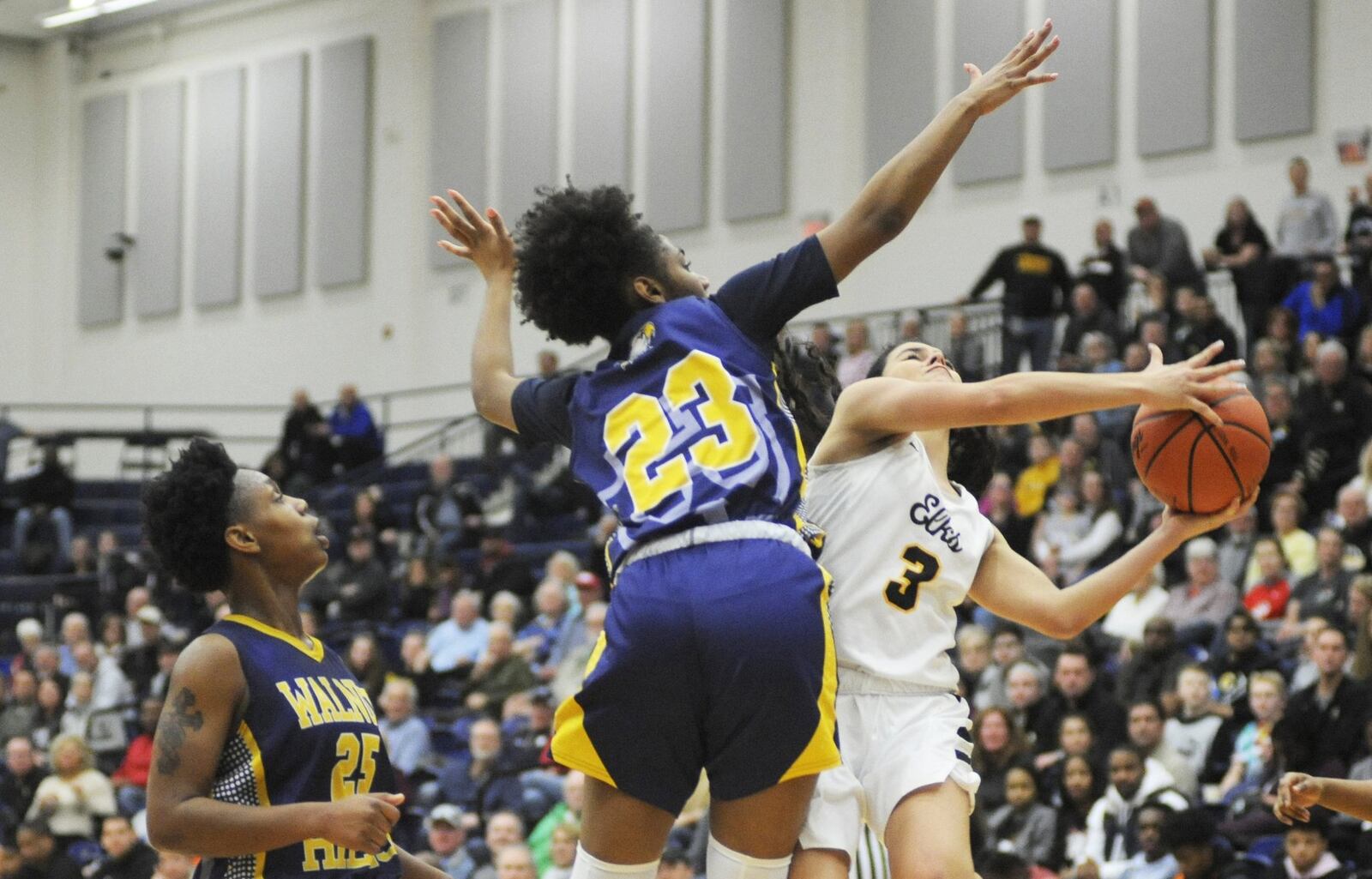 Amy Velasco of Centerville dodges Sean Kelly Darks (23). Centerville defeated Cin. Walnut Hills 54-39 in a girls high school basketball D-I regional final at Fairmont’s Trent Arena on Wednesday, March 6, 2019. MARC PENDLETON / STAFF